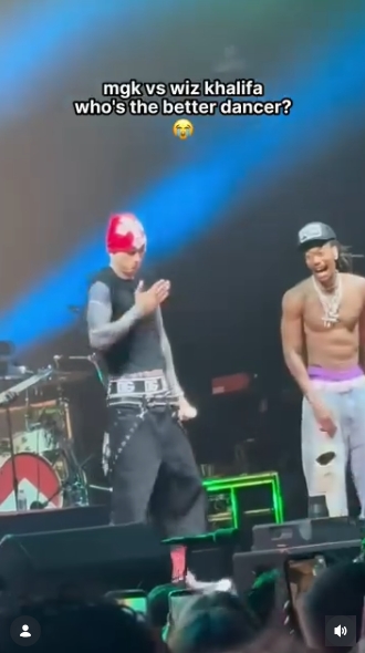 MGK and Wiz Khalifa react to one another's performances during their onstage showdown, with both artists appearing amused by the exchange. Their playful chemistry drew laughs from the crowd as the battle continued. | Source: Instagram/mgkmagic