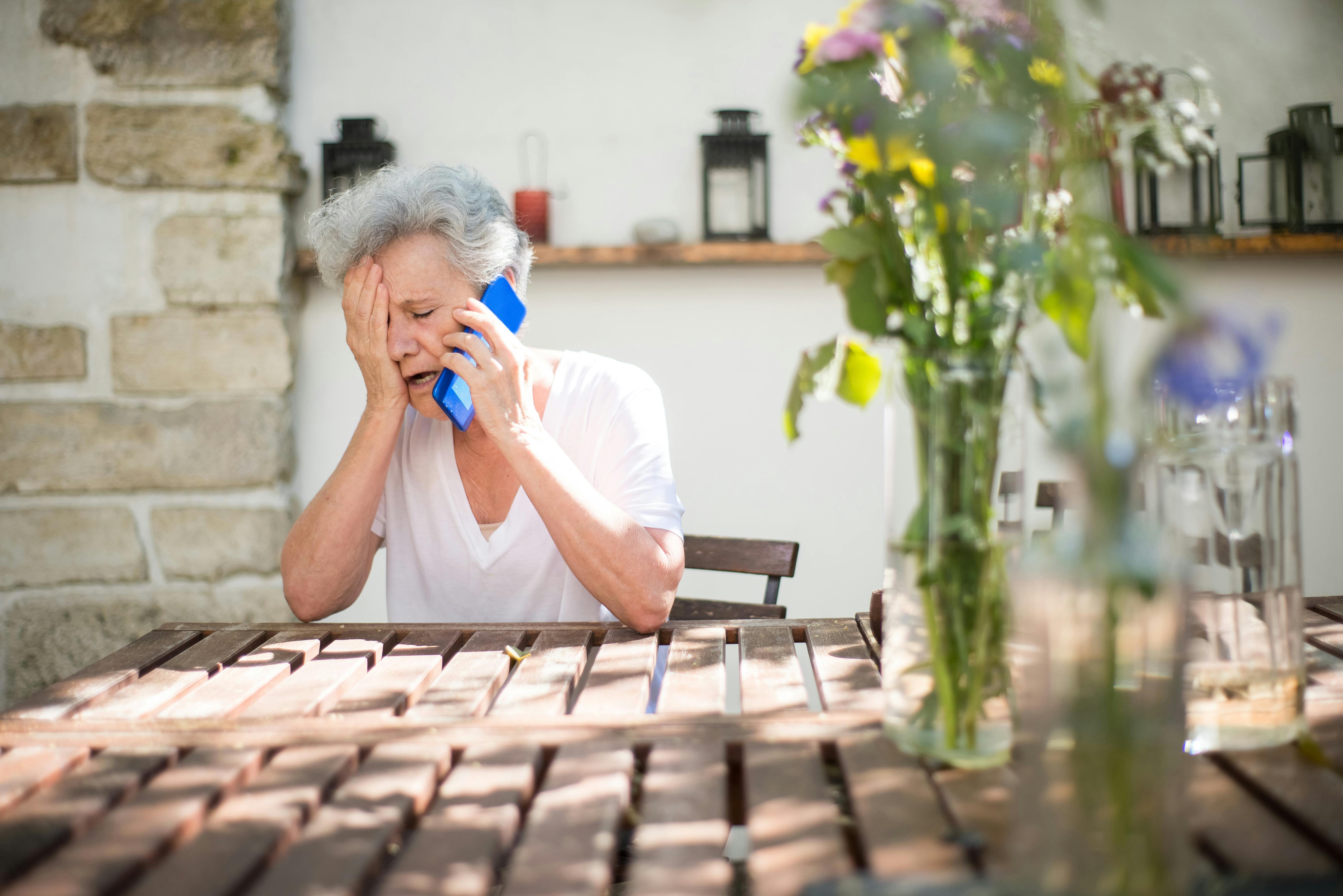 A sad elderly woman on a phone call | Source: Pexels