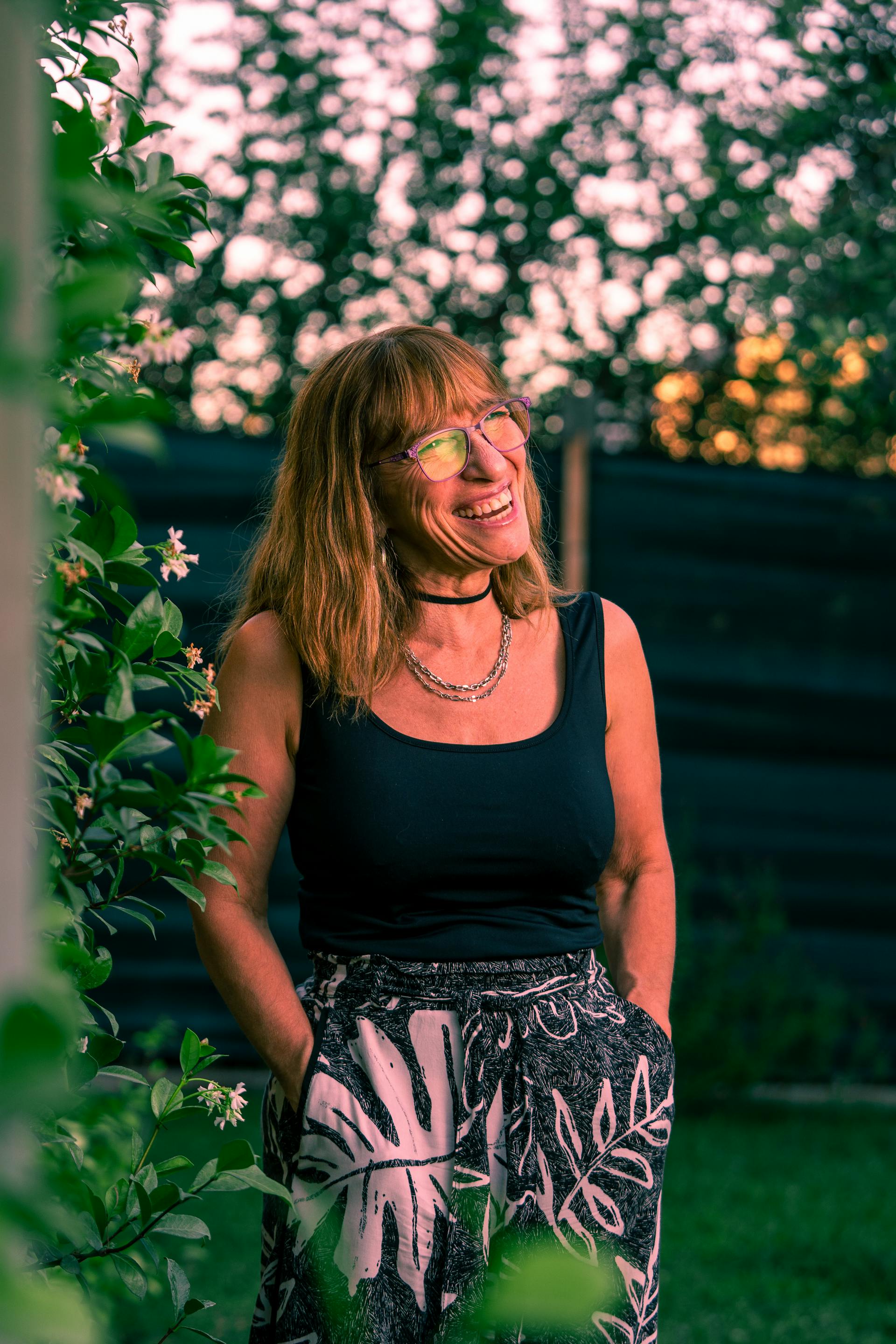 A smiling woman standing in the garden | Source: Pexels