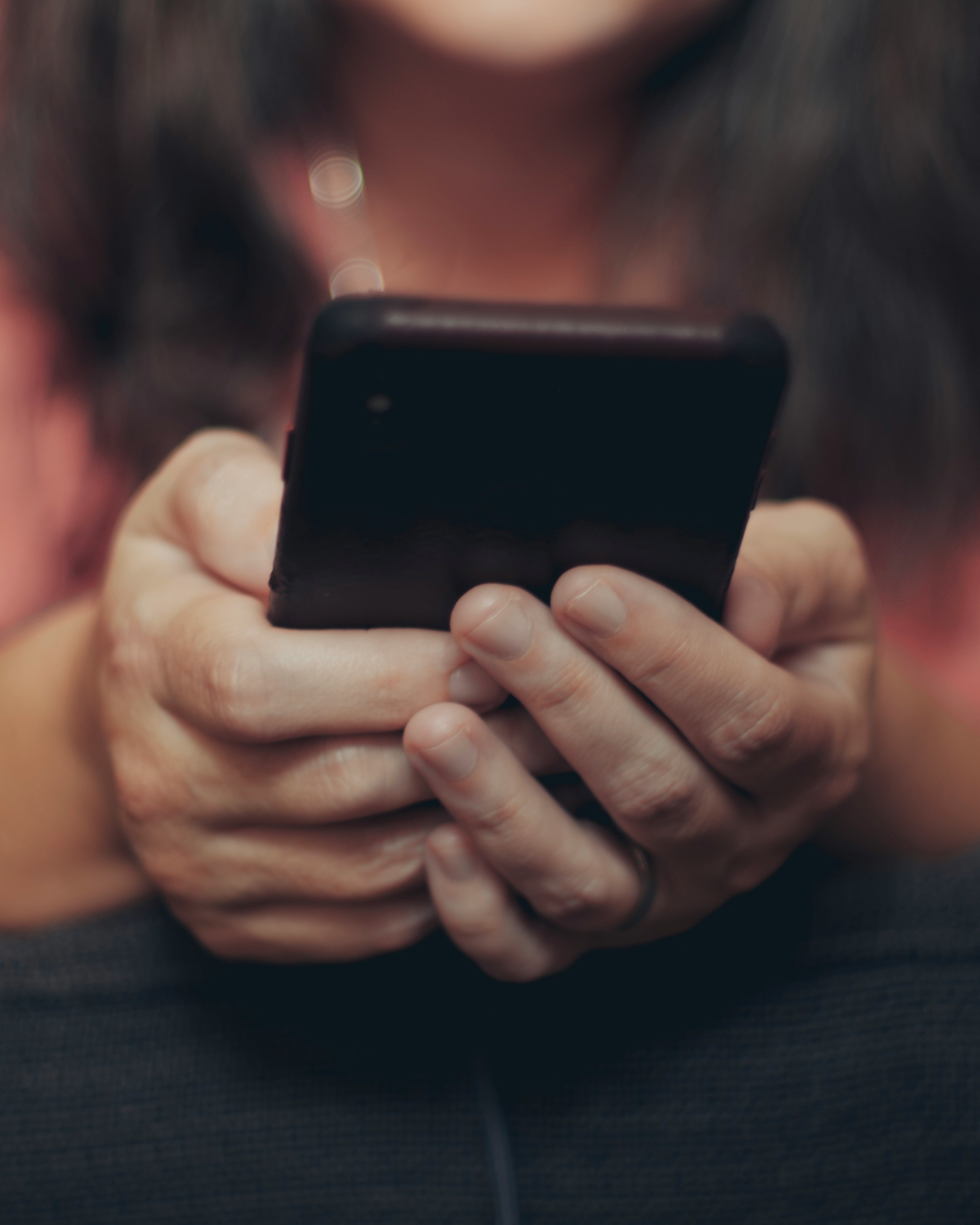 A pair of hands holding a cellphone | Source: Unsplash