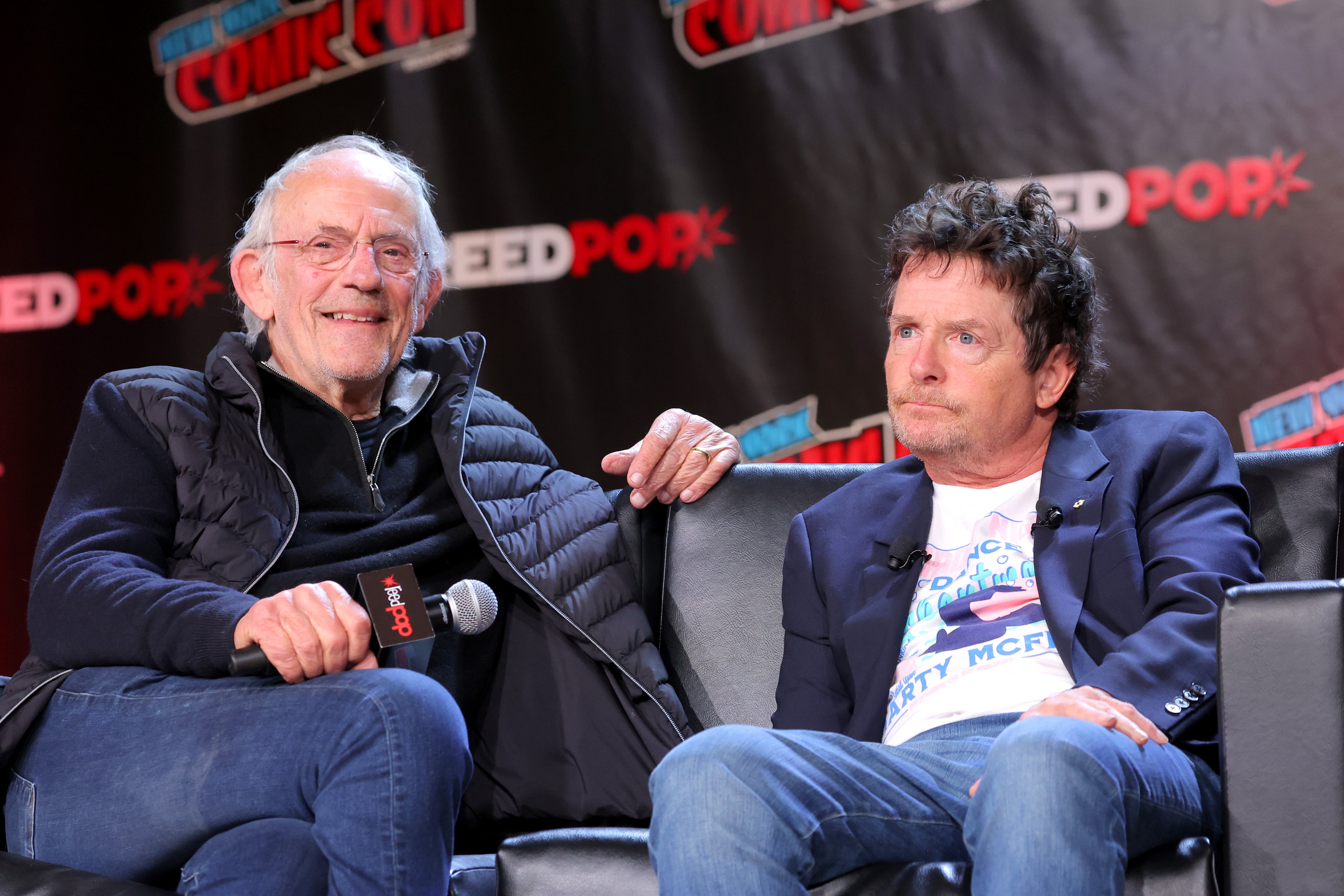 Christopher Lloyd and Michael J. Fox at a "Back To The Future" Reunion panel at New York Comic Con on October 8, 2022, in New York City | Source: Getty Images