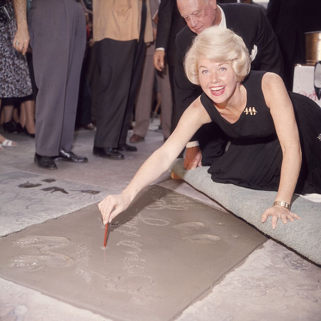 Doris Day signing her name in cement on Hollywood Boulevard, Hollywood, on January 19, 1961 | Source: Getty Images