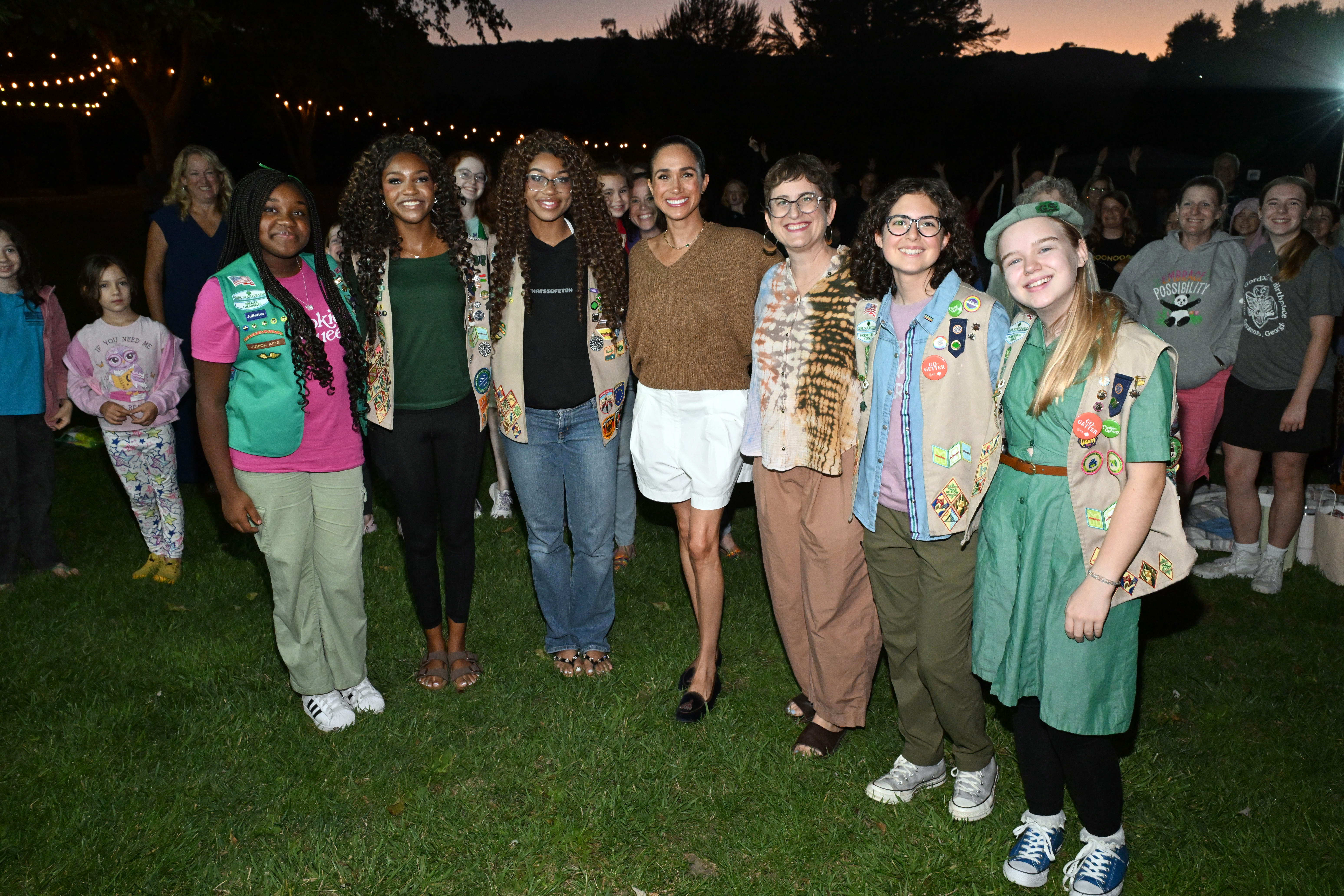 The Duchess of Sussex poses with campers and participants featured in "Cookie Queens" as families gathered for the outdoor screening celebrating the upcoming documentary. | Source: Getty Images