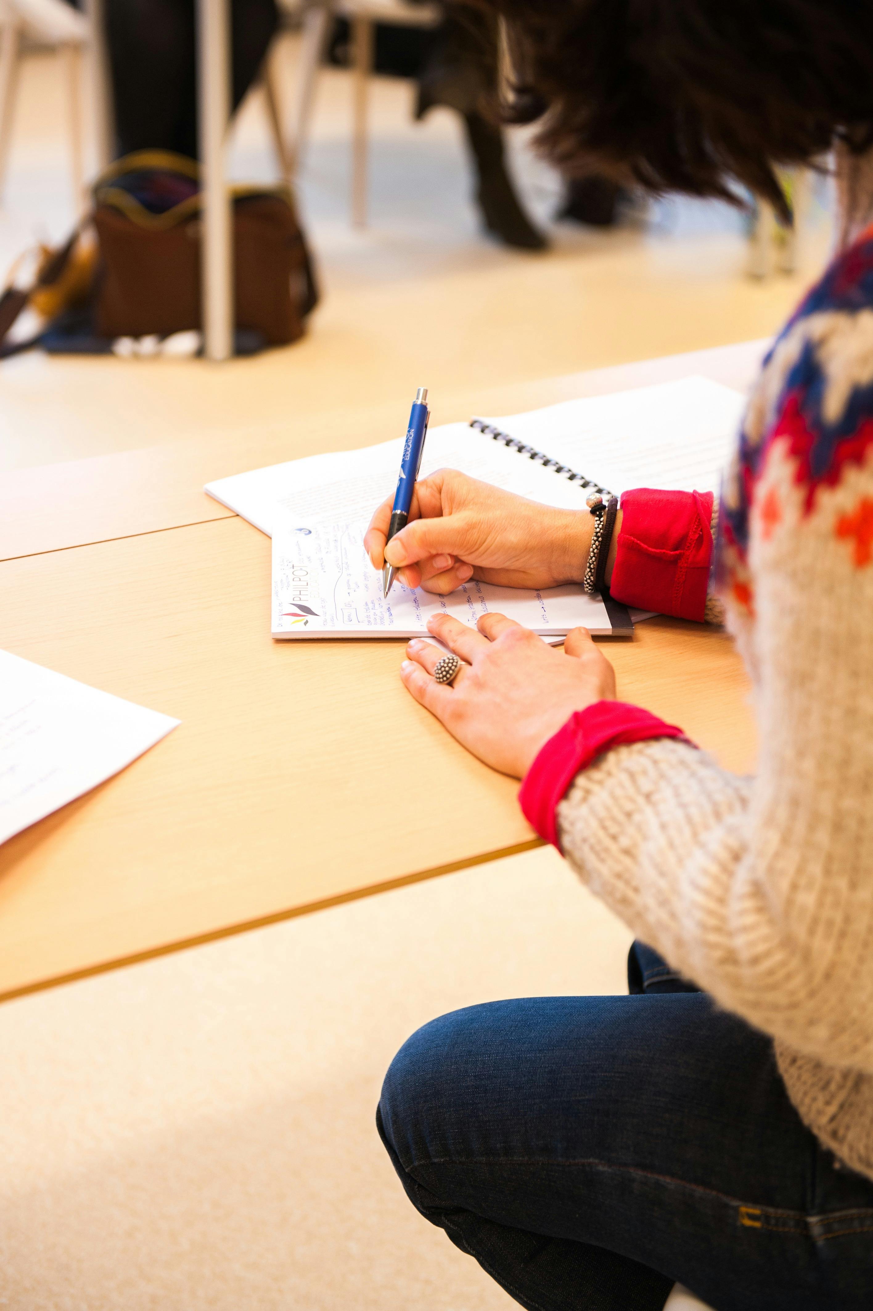 Woman writing a note | Source: Pexels