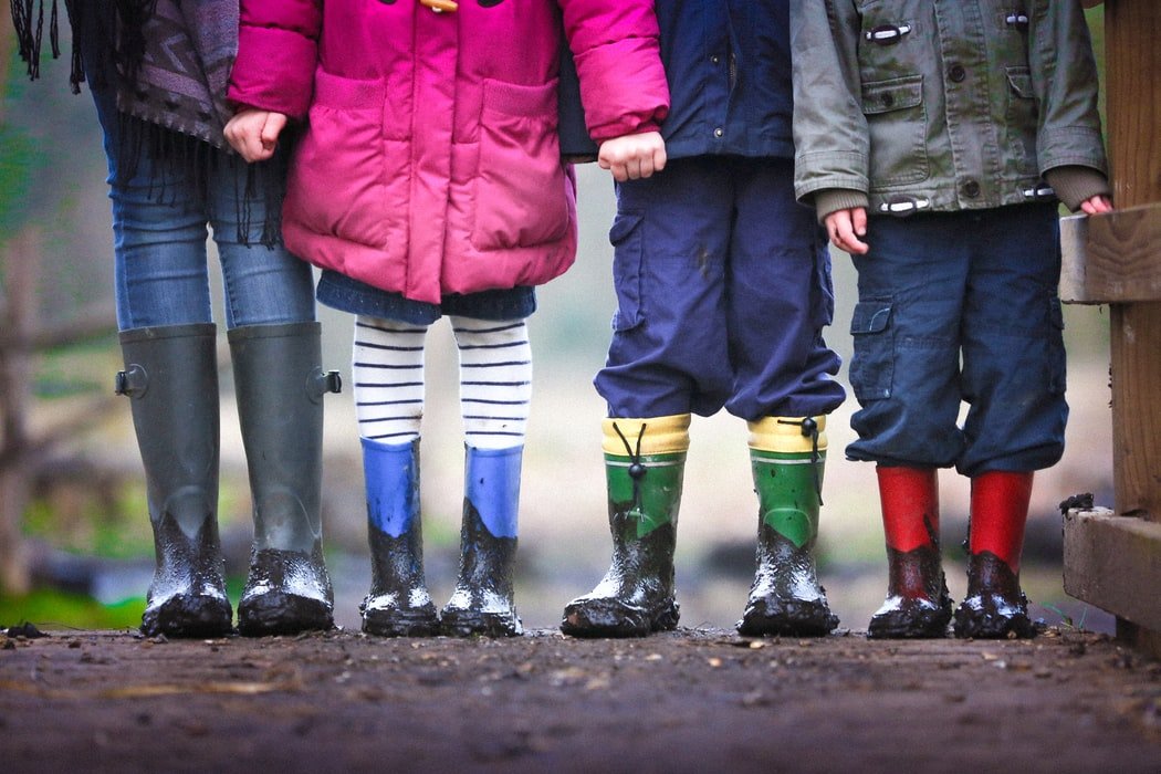 A group of children in galoshes | Source: Unsplash