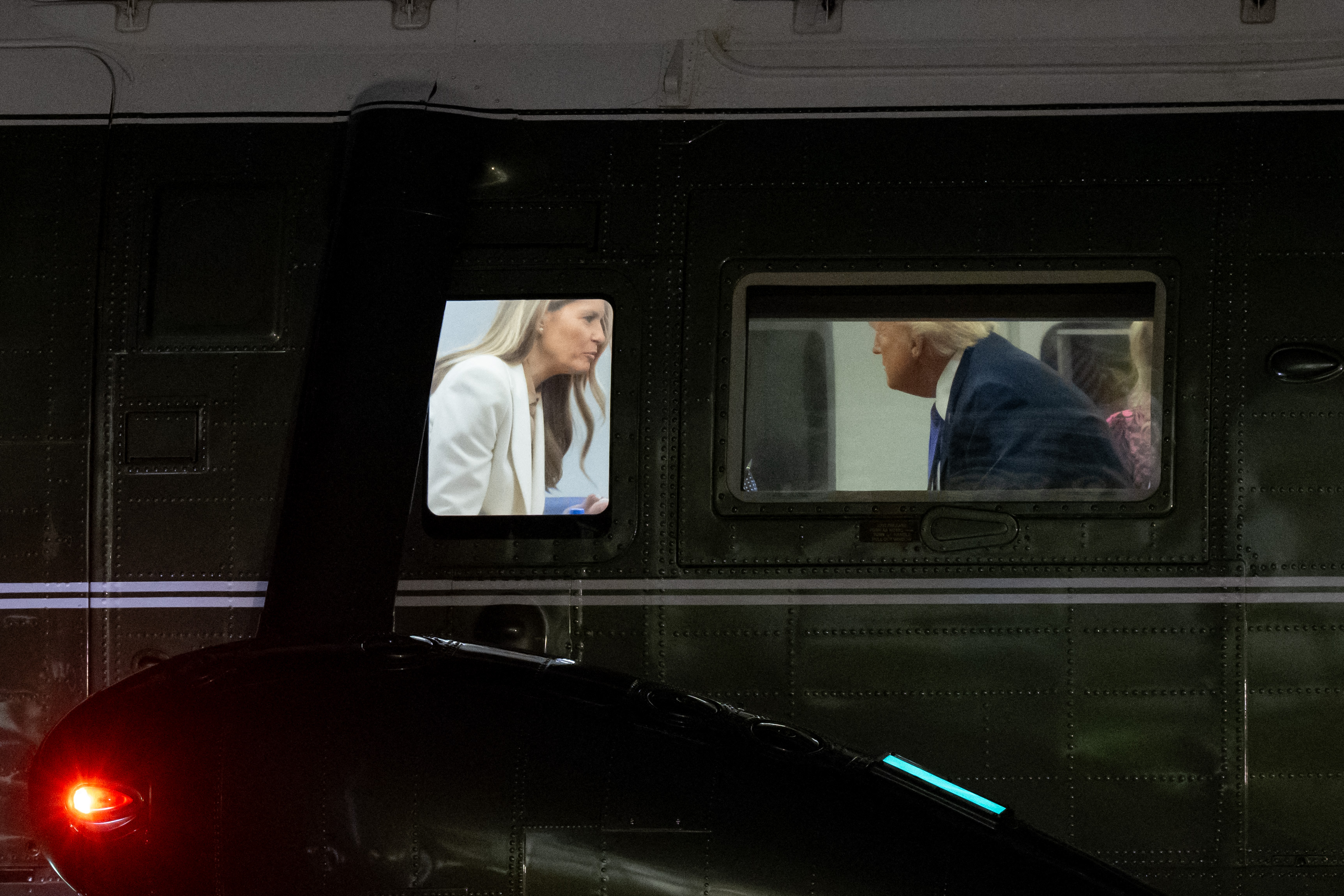 Melania and Donald Trump talking to each other as they arrive back in Washington, D.C. | Source: Getty Images