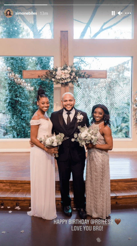 Screenshot of photo of Simone, Ron and Adria Biles posing at Ron Biles' wedding in 2020. | Source: Instagram/simonebiles