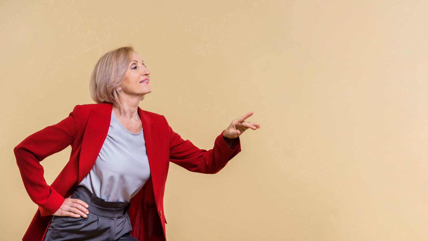 A senior woman pointing her finger | Source: Freepik