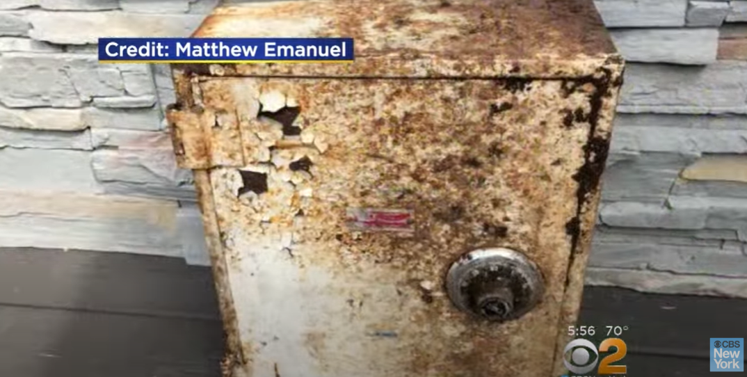 The weathered safe Matthew Emanuel and his wife, Maria Colonna-Emanuel, found in their Todt Hill, Staten Island, yard on May 15, 2018 | Source: YouTube/CBS New York