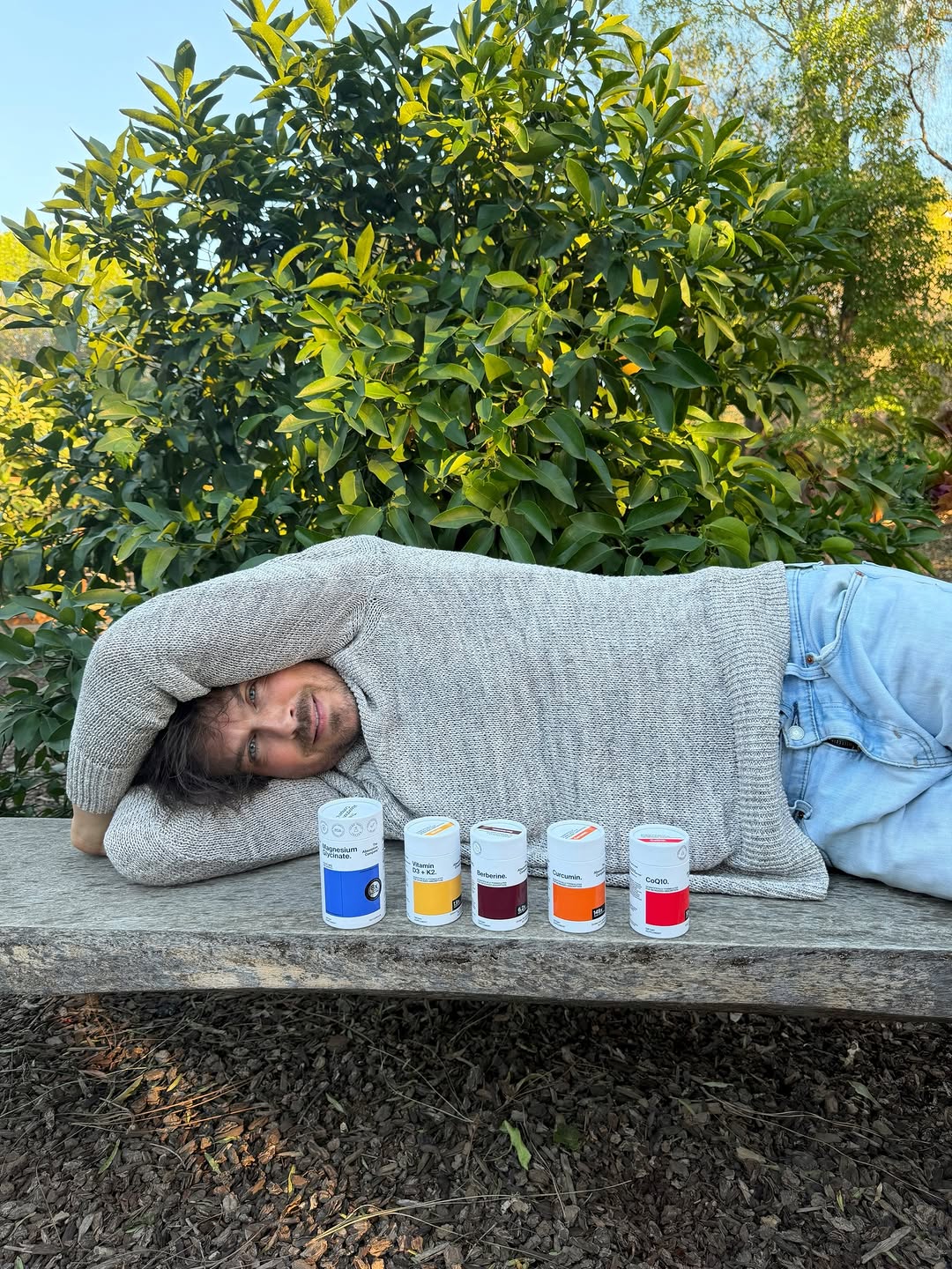 Ian Somerhalder lying down on a bench outside. | Source: Instagram/iansomerhalder