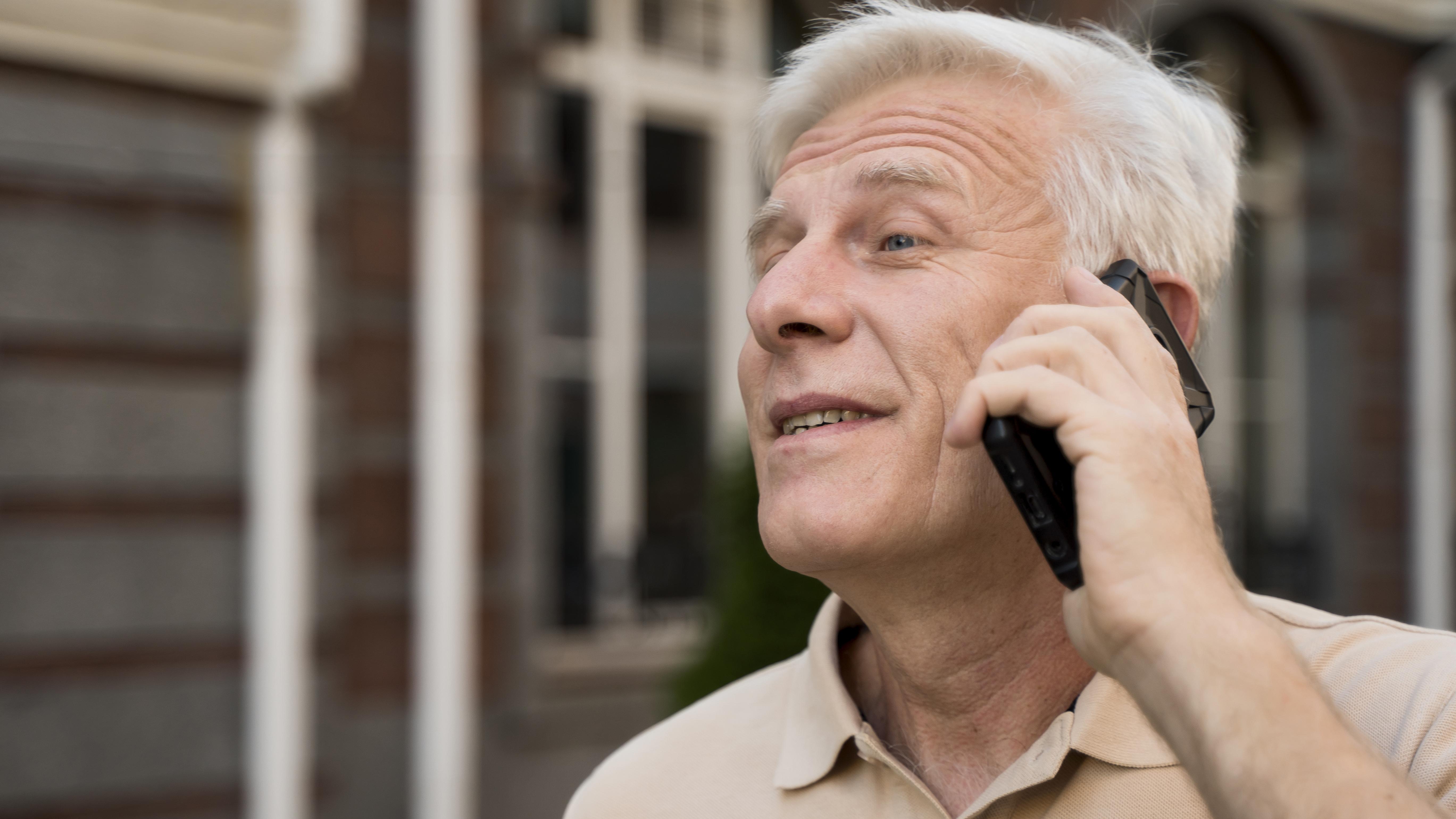 A senior man talking on the phone | Source: Freepik