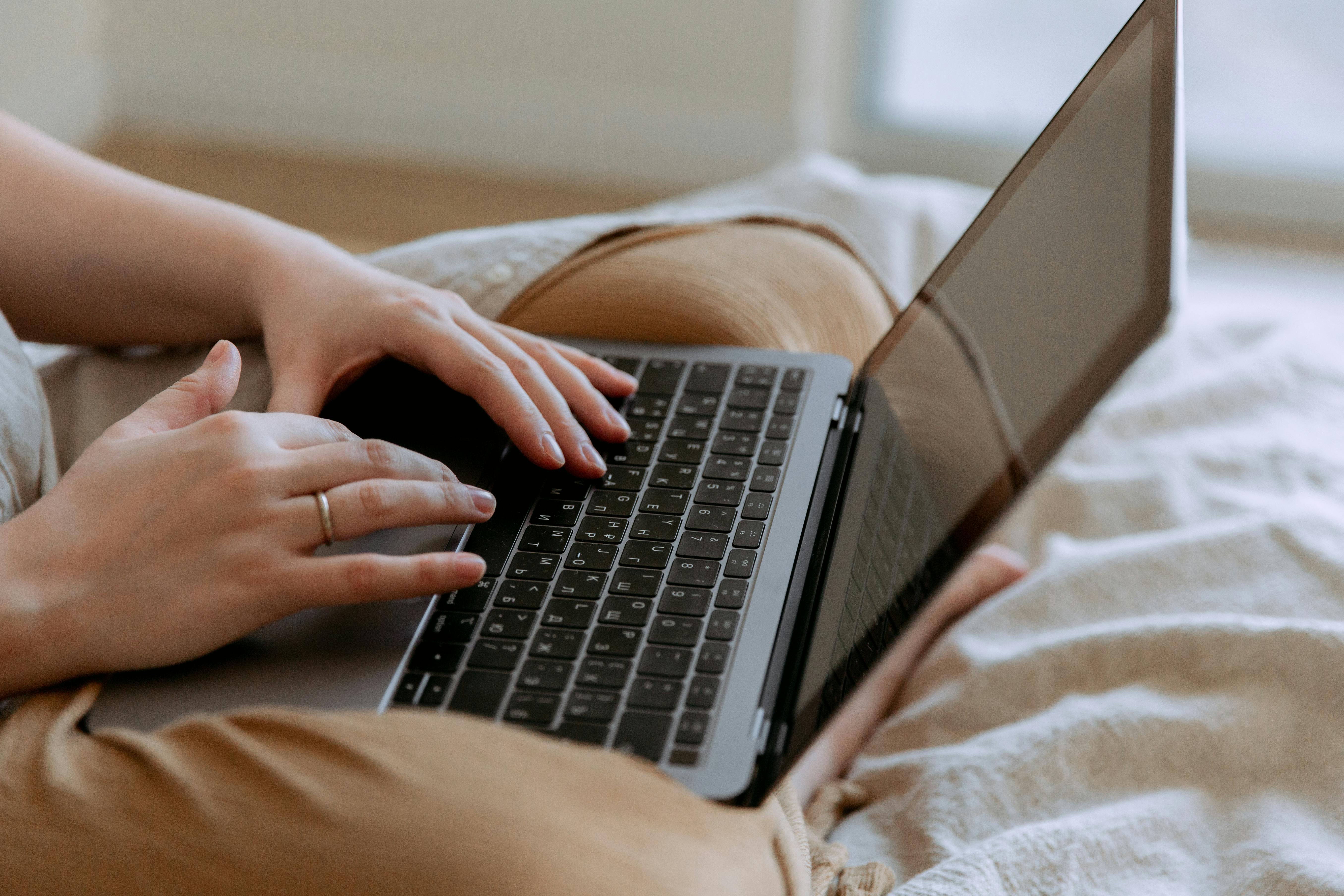 A woman's hands texting something on a laptop | Source: Pexels