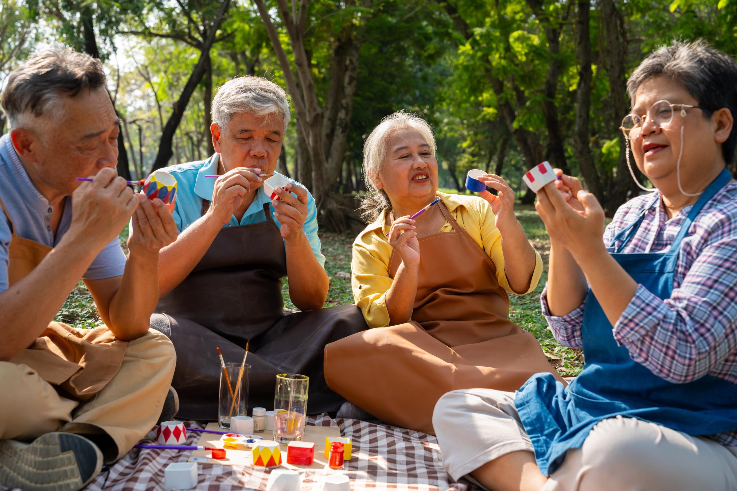 A group of older adults painting outdoors | Source: Shutterstock