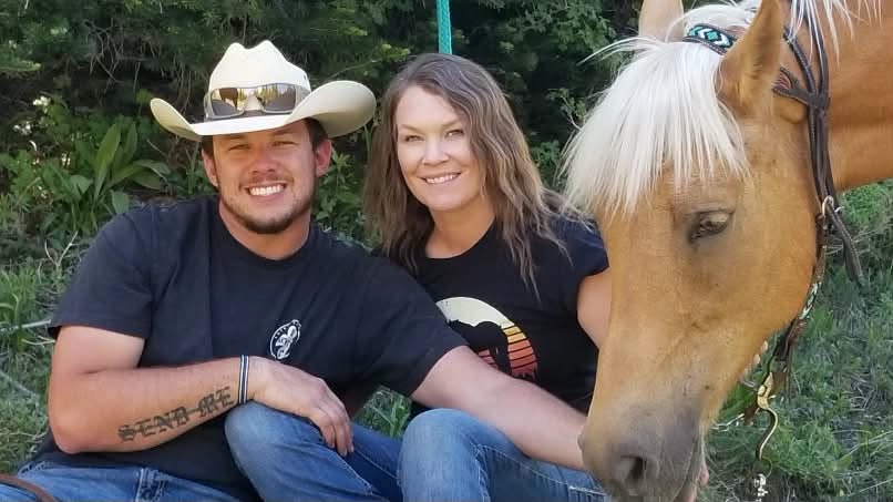 Austin Scott, whose courageous actions helped distract the In-N-Out shooter, and his wife Connie James, who provided immediate medical care that saved her husband's life, in a photo with a horse posted on August 3, 2026. | Source: Facebook/Kaitlyn Ross
