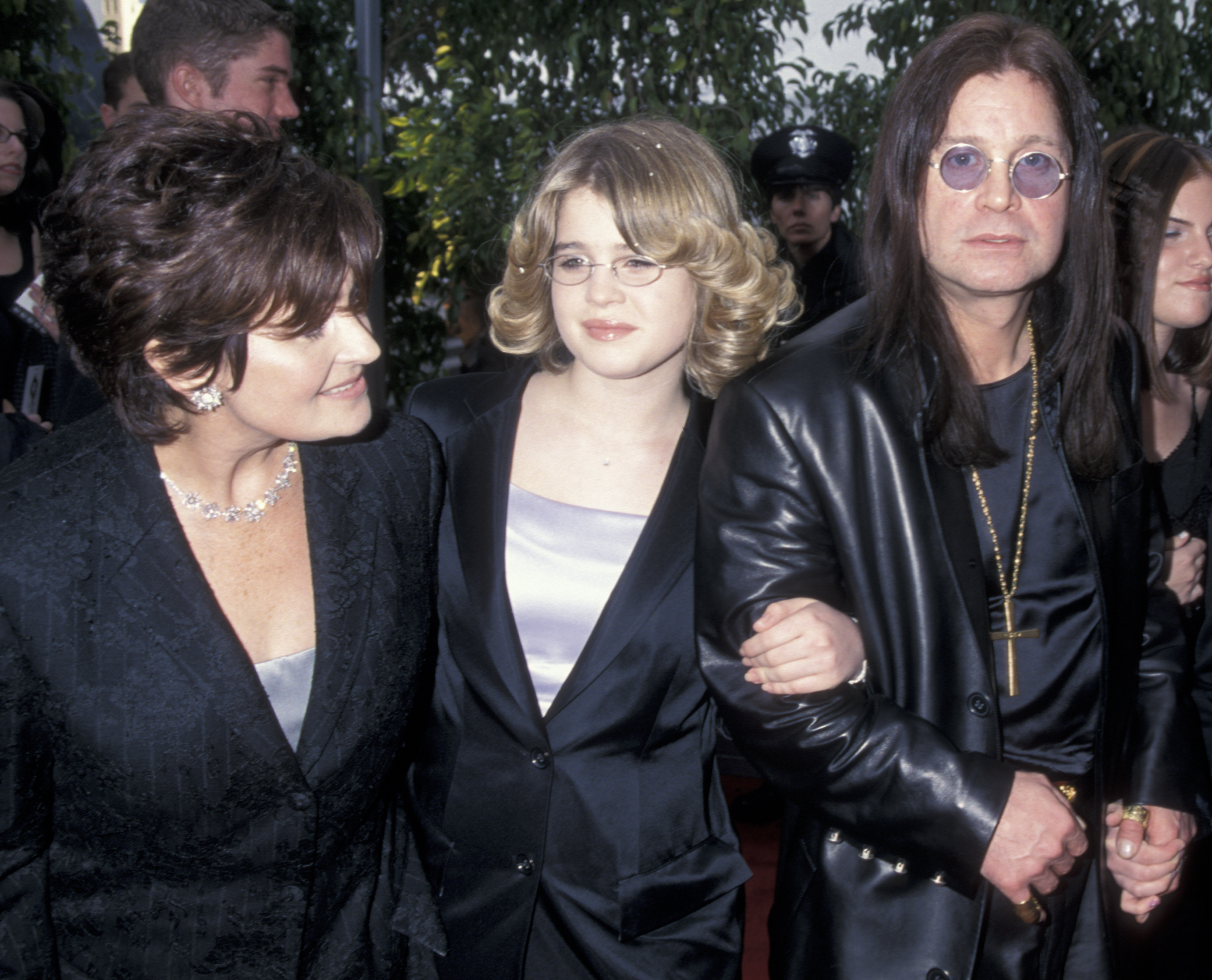 A fresh-faced Kelly beams between her parents Sharon and Ozzy Osbourne at the 42nd Annual Grammy Awards on 23 February 2000 — the picture of rock royalty innocence before the storm of fame, fashion, and reinvention began.