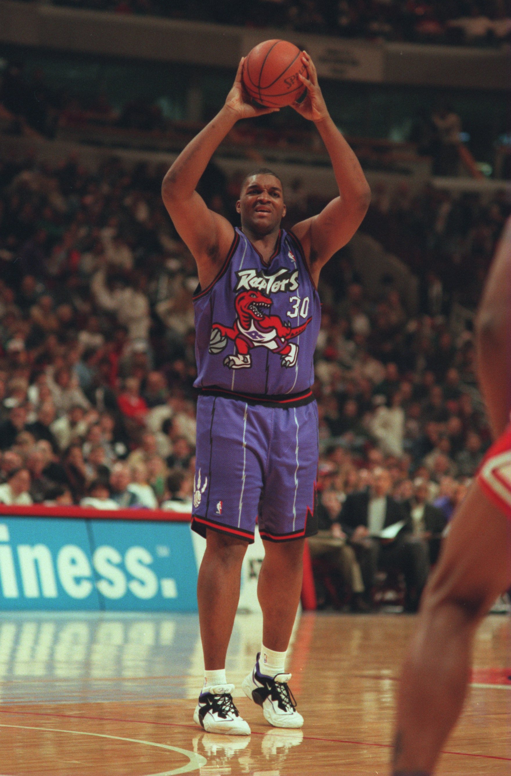 Oliver Miller #30 of the Toronto Raptors looks to pass during the Raptors 113-104 loss to the Chicago Bulls at the United Center in Chicago, Illinois, on December 22, 1995 | Source: Getty Images