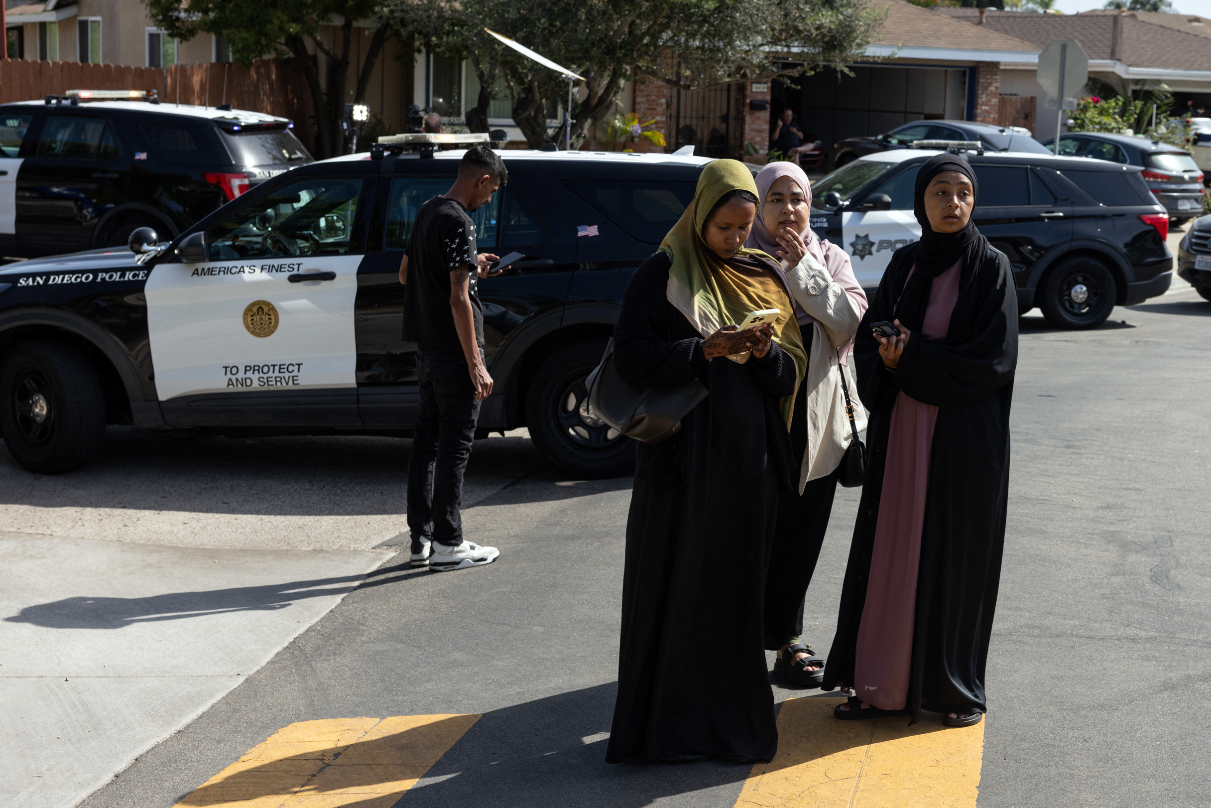 Women wait for information outside a reunification center following the shooting at the Islamic Center of San Diego in southern California on May 18, 2026 | Source: Getty Images