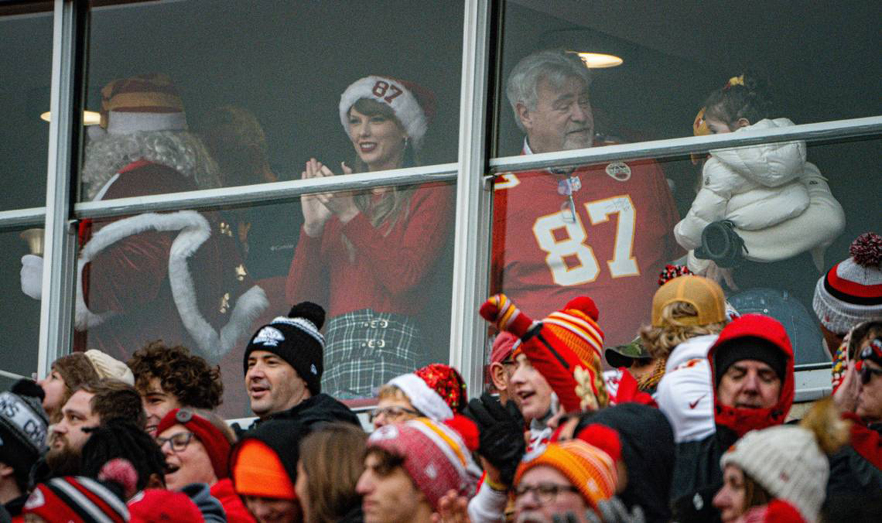 Taylor Swift watching the Kansas City Chiefs play the Las Vegas Raiders in a suite with Travis Kelce's father, Ed Kelce, on December 25, 2023. | Source: Getty Images