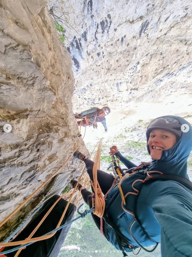 Laura Dahlmeier and her climbing partner smile at the camera while hanging from a steep rock face, from a post dated June 5, 2025 | Source: Instagram/laura_dahlmeier