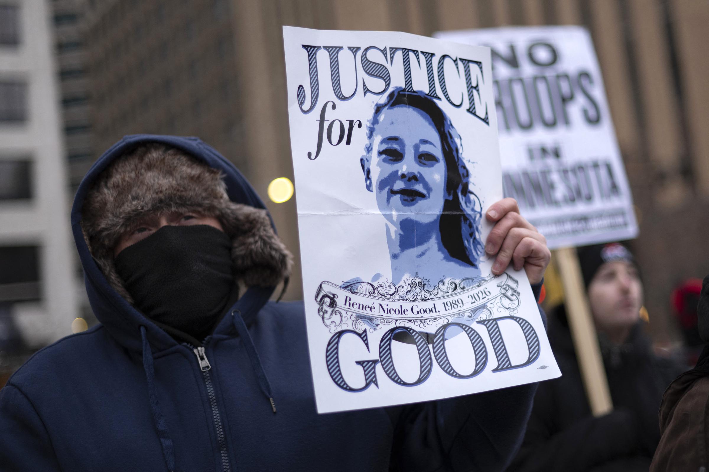 A demonstrator holds a sign with a photo of Renee Nicole Good, the 37-year-old woman fatally shot by an ICE officer, as he takes part in the nationwide "Stop ICE Terror" rally in Minneapolis, Minnesota | Source: Getty Images