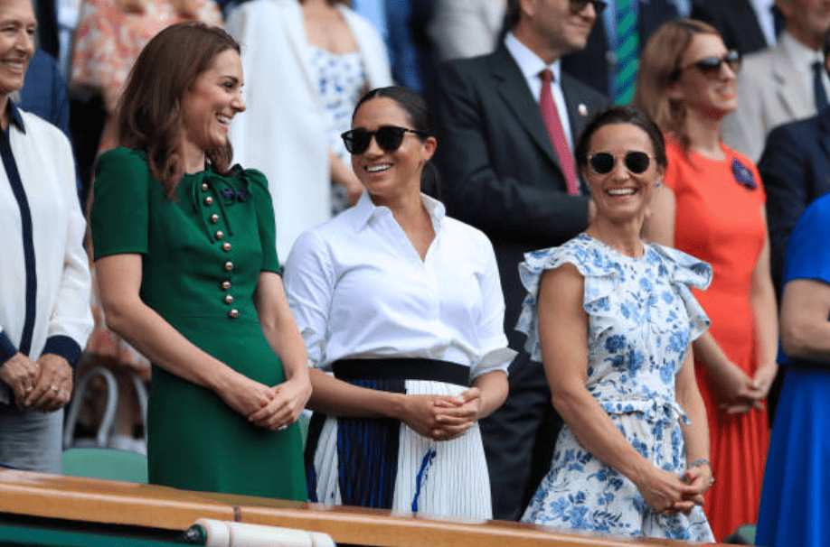 Kate Middleton, Meghan Markle and Pippa Matthews laugh together while enjoying a chat in the Royal Box at the Wimbledon Championship on July 13, 2019 in London, England | Source: Simon Stacpoole/Offside/Getty Images