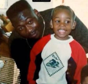 Laurence Thomaz poses with a young Wiz Khalifa in a childhood photo that surfaced online on February 14, 2026, following news of Thomaz's death. | Source: X/RAZOR BLADE