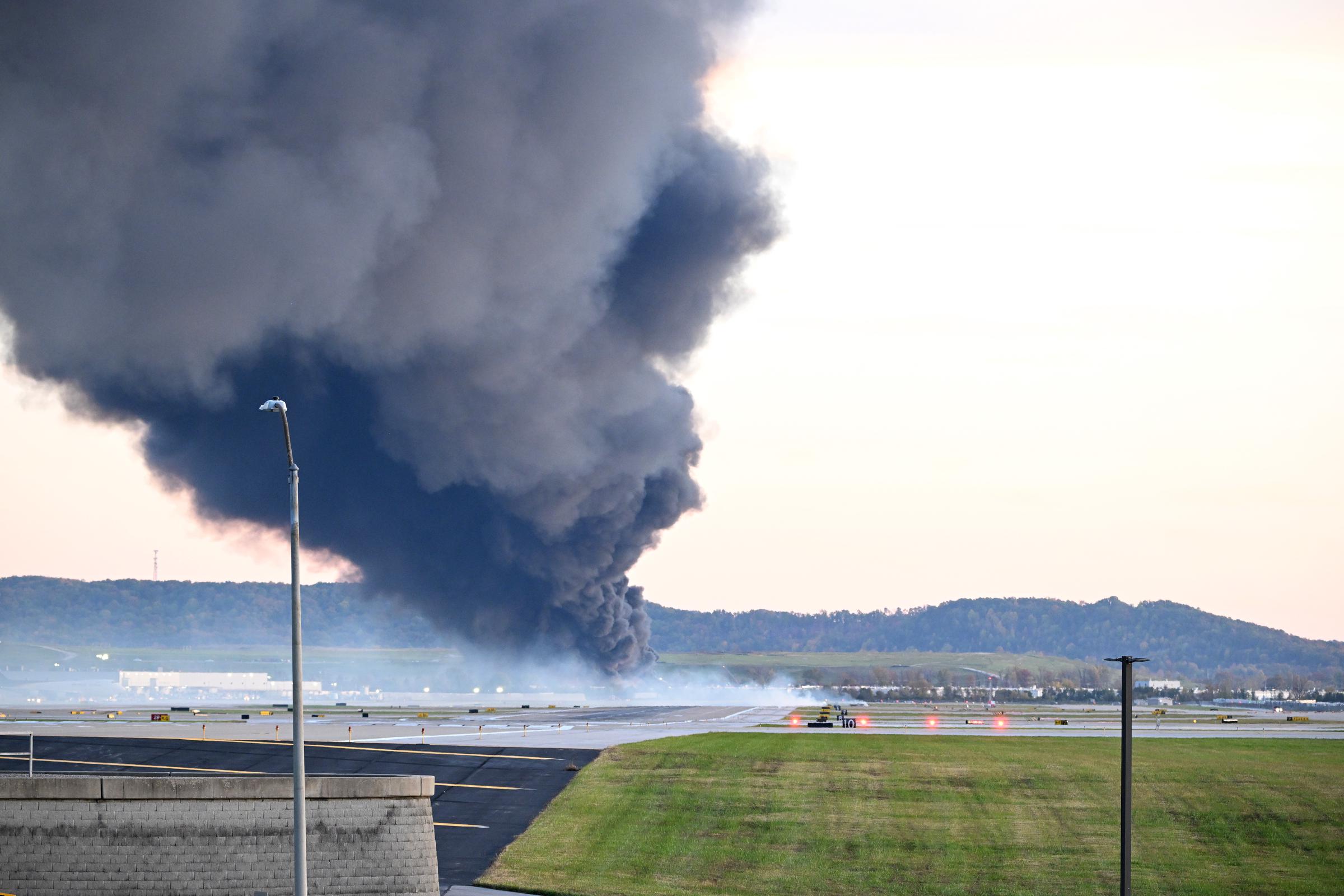 Fire and smoke rise from the site where a UPS cargo plane crashed in Louisville Muhammad Ali International Airport on November 4, 2025 | Source: Getty Images