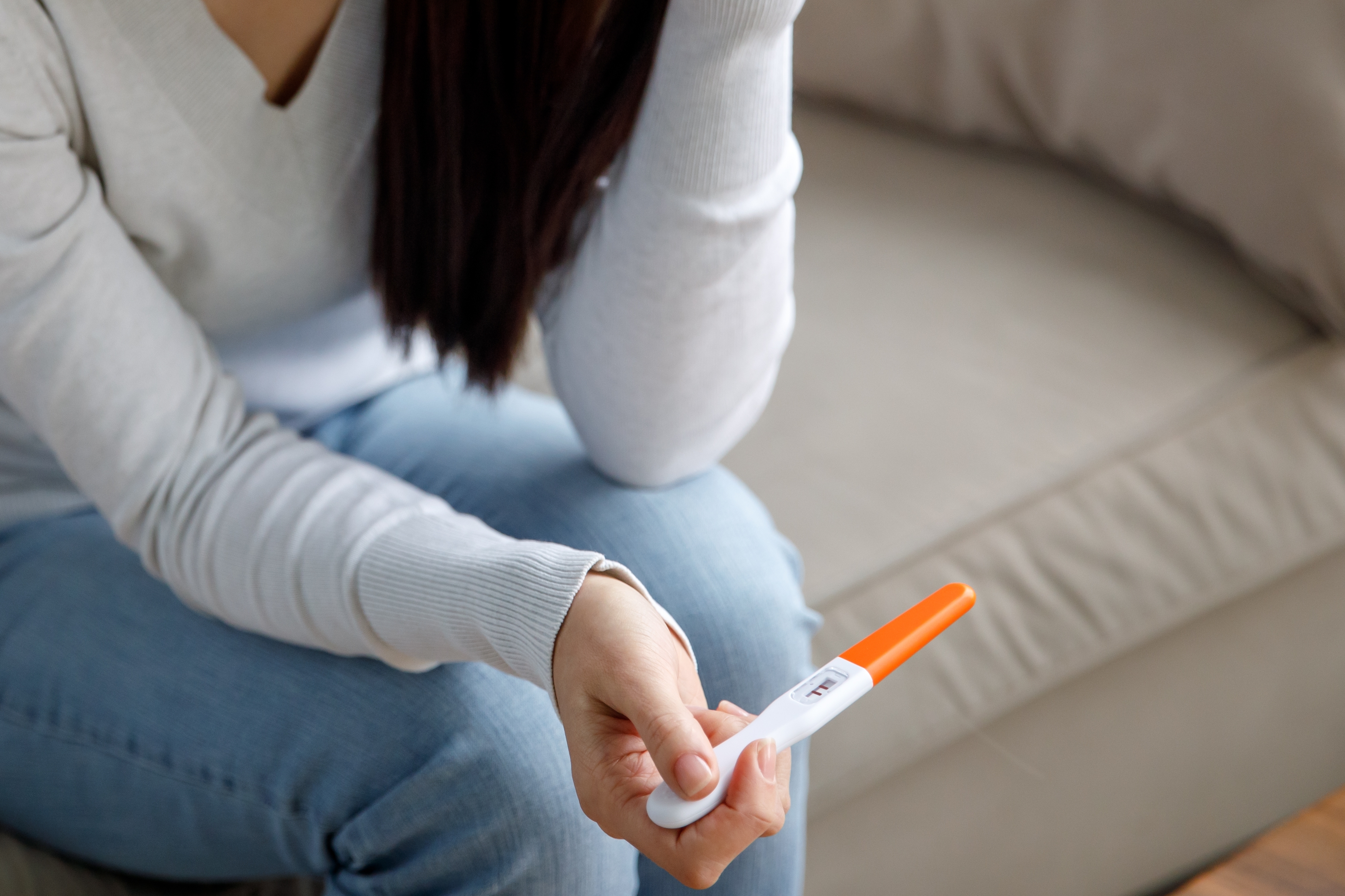 A woman holding a pregnancy test  | Source: Shutterstock