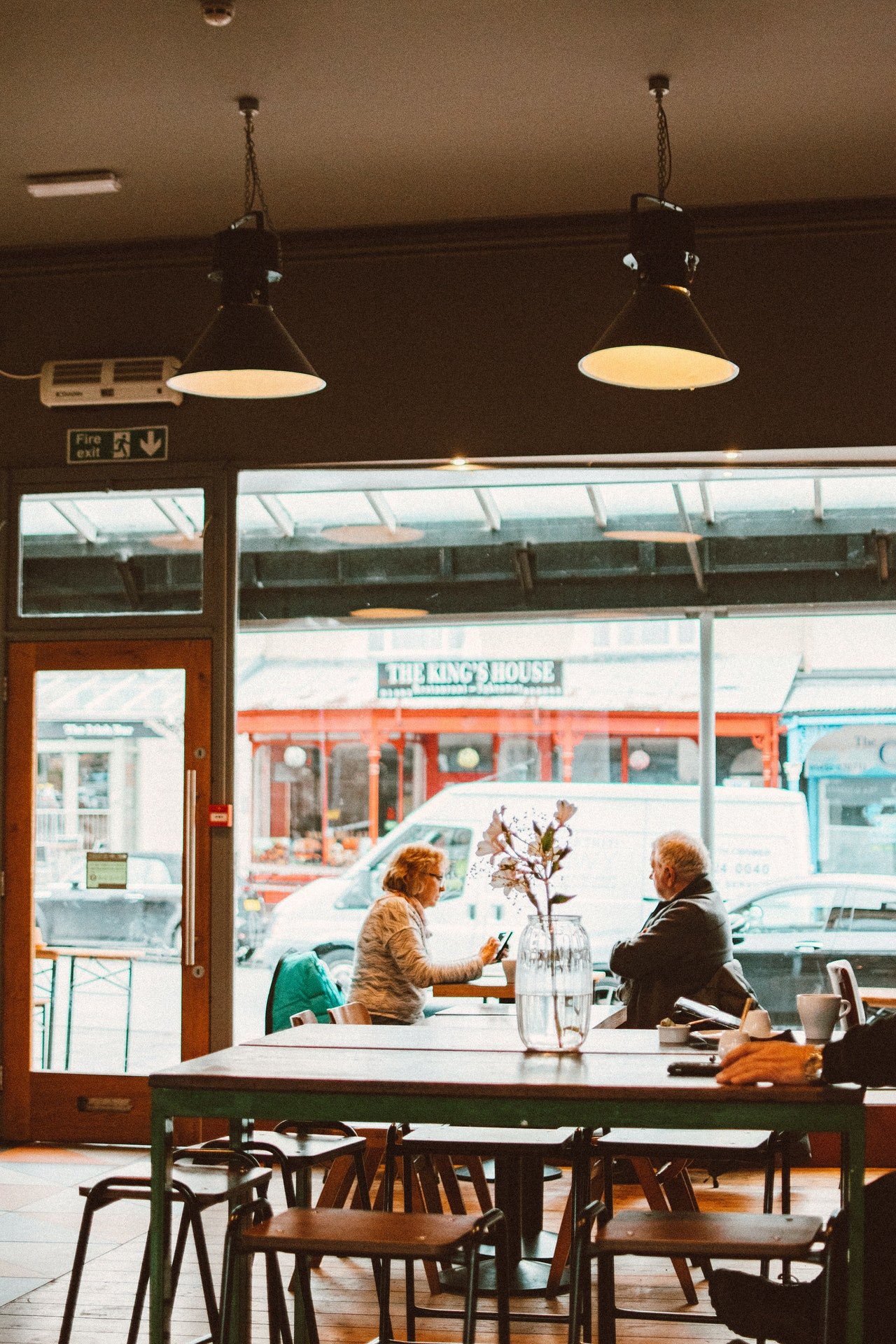 An elderly couple sitting by the window of a restaurant | Source: Pexels