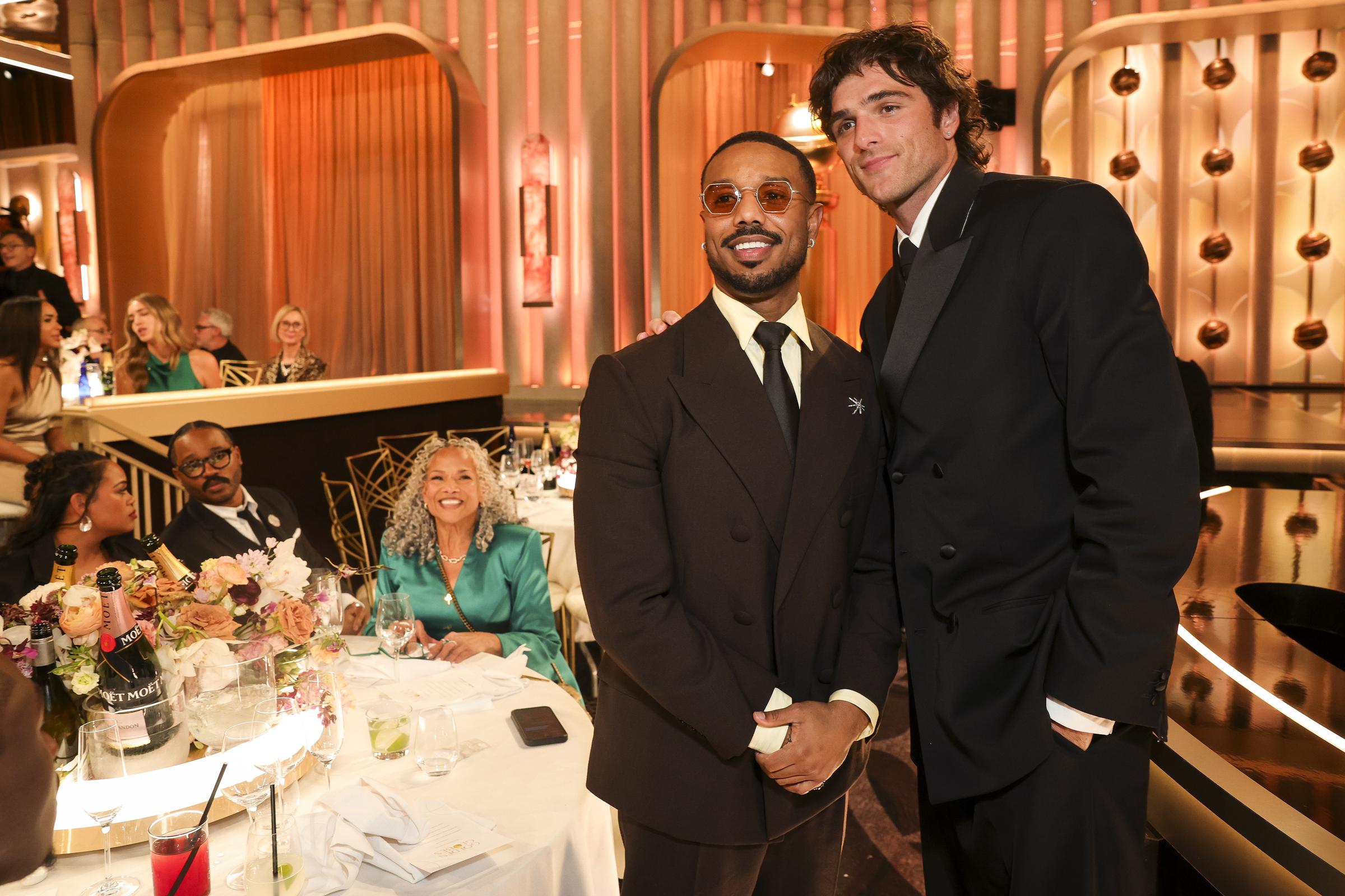 Michael B. Jordan posing for a picture with Jacob Elordi, as Donna Jordan looks on with a smile while seated next to Ryan Coogler and his wife. | Source: Getty Images