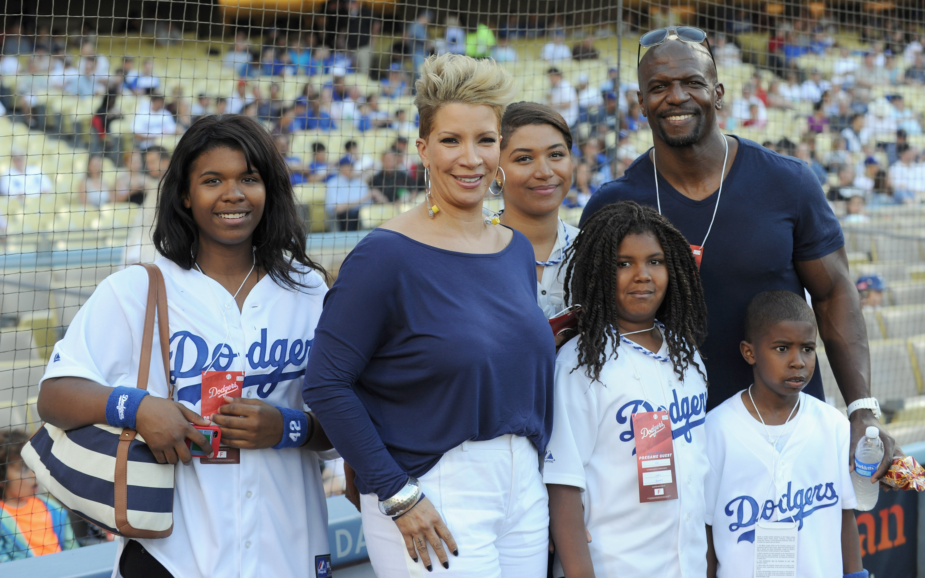 Rebecca and Terry Crews with some of their children pose before Rebecca sings the national anthem during the Major League Baseball on May 11, 2013 | Source: Getty Images