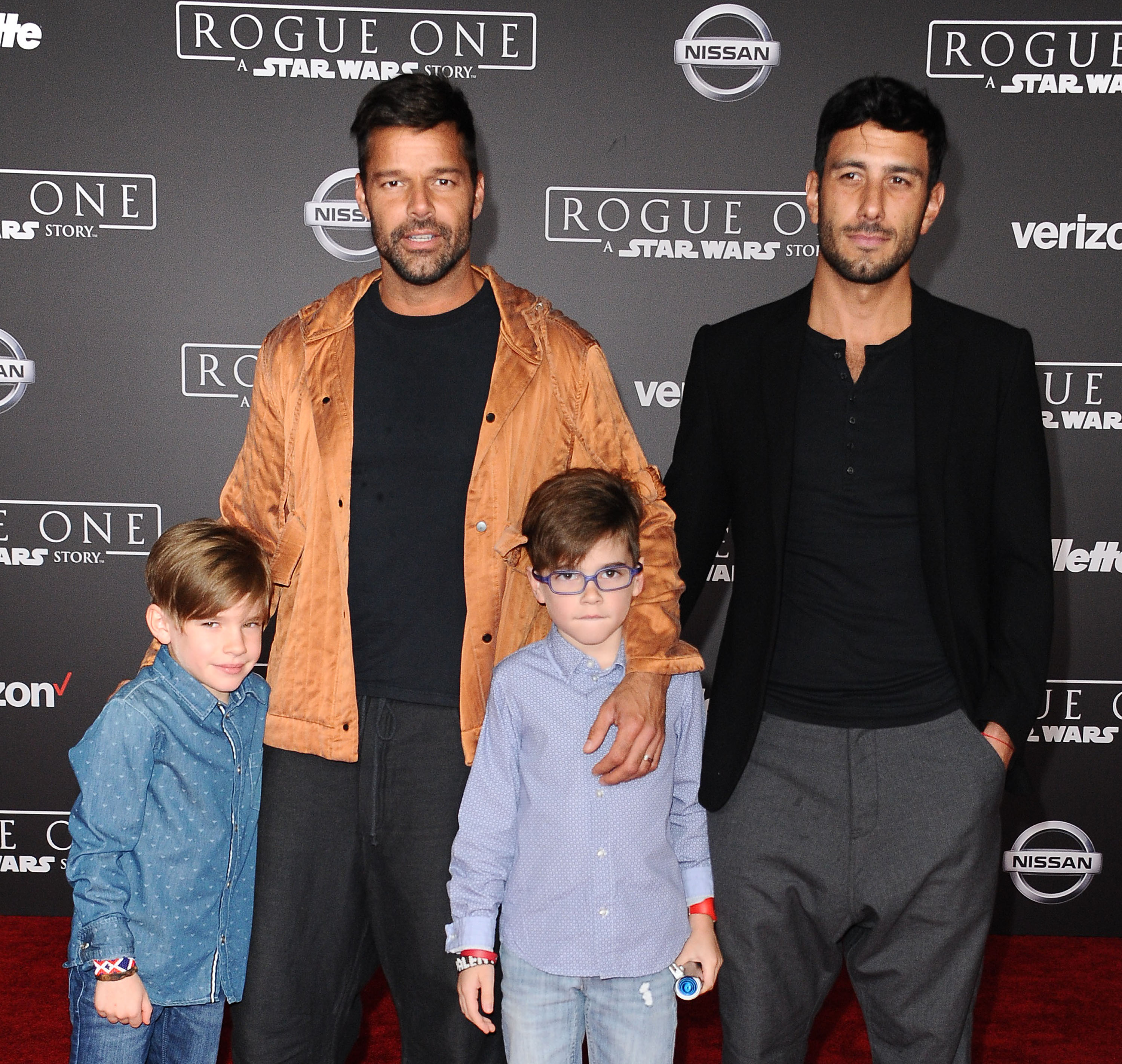 Ricky Martin stands beside Jwan Yosef, Matteo Martin, and Valentino Martin on the red carpet at the "Rogue One: A Star Wars Story" premiere in Hollywood.