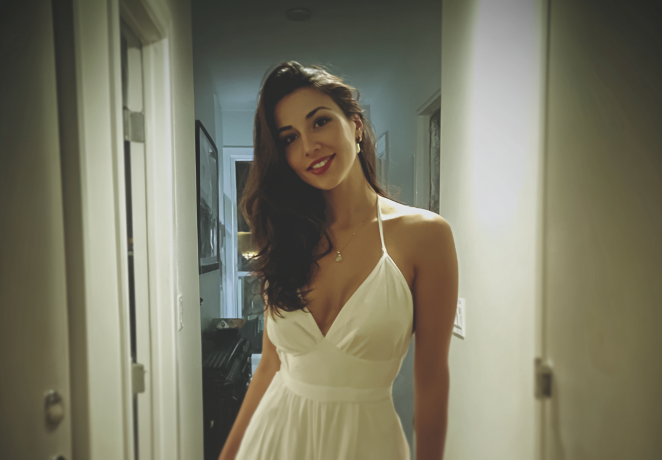 A smiling woman standing in a home hallway | Source: Midjourney