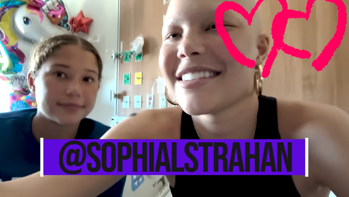 Sophia Strahan sits by her sister Isabella's hospital bed in June 2024. | Source: YouTube/IsabellaStrahan