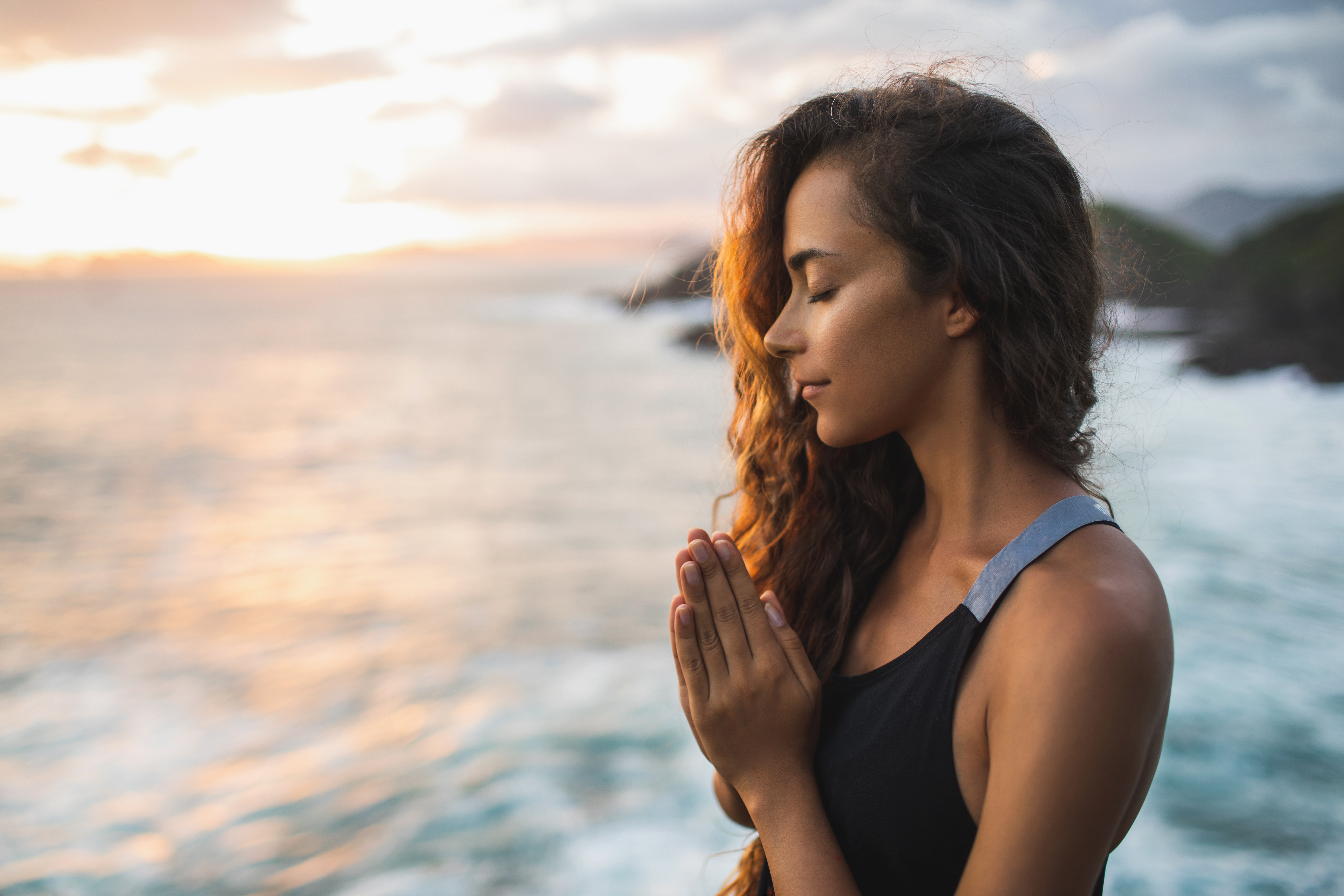 A young woman praying and meditating | Source: Shutterstock