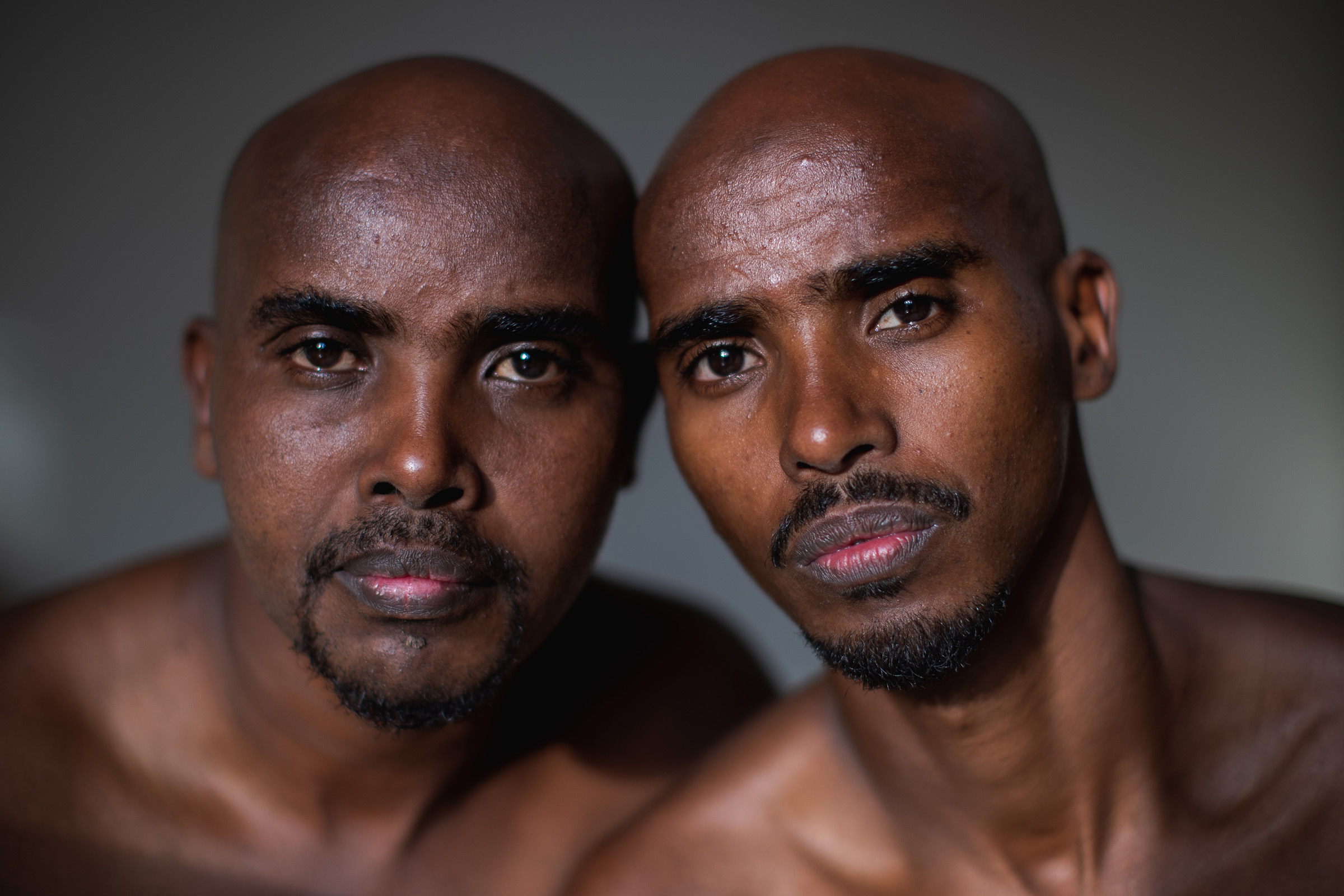 Sir Mo Farah and his twin brother, Hassan, sit shoulder to shoulder against a grey studio backdrop in Weybridge on 18 July 2019, their faces almost mirror images of each other. The two were inseparable as small children in Somaliland, and it was with his brother that Farah was sent to live with an uncle in neighbouring Djibouti — before the woman arrived, and only one of them was taken.