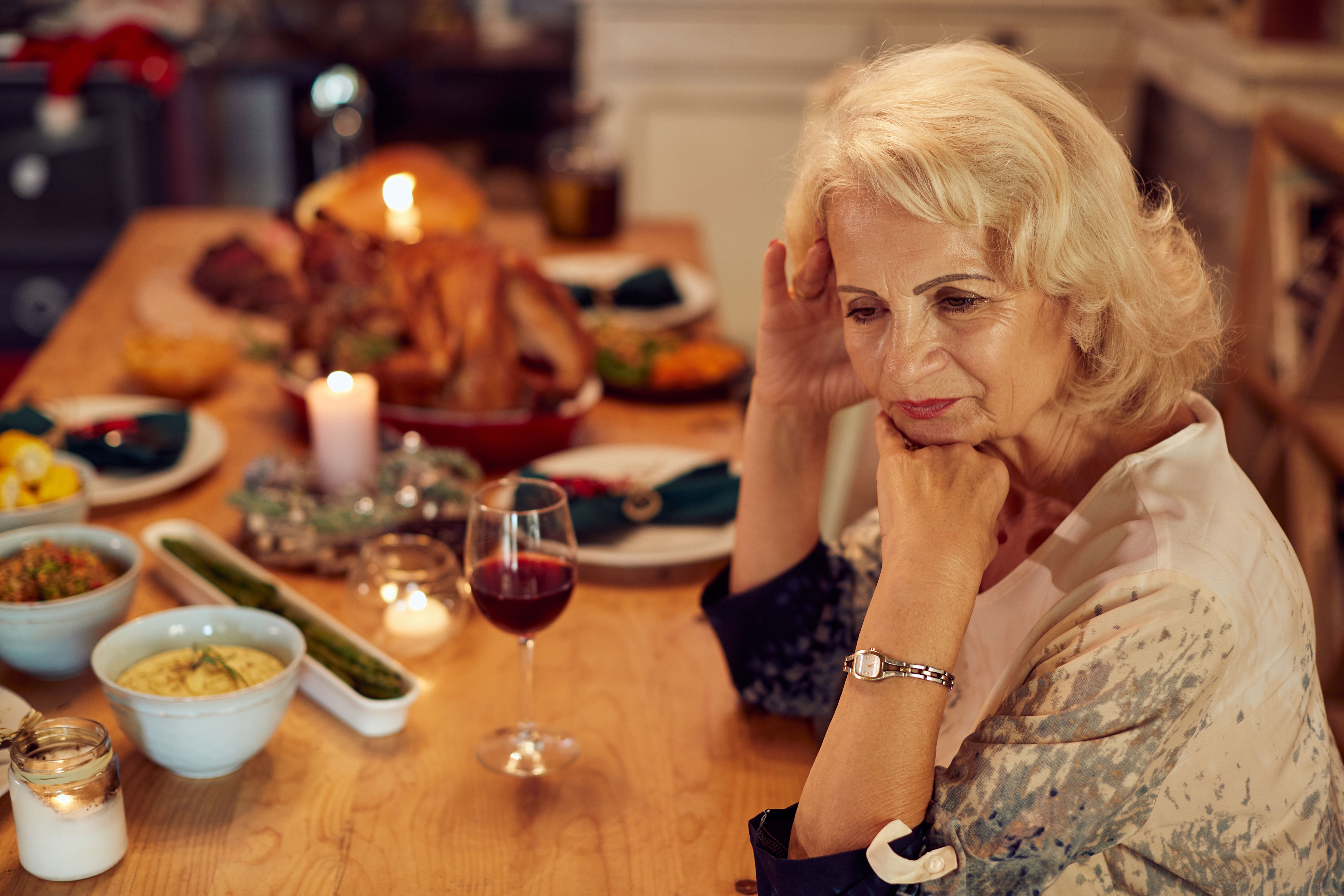 An elder woman upset at a dinner table | Source: Getty Images