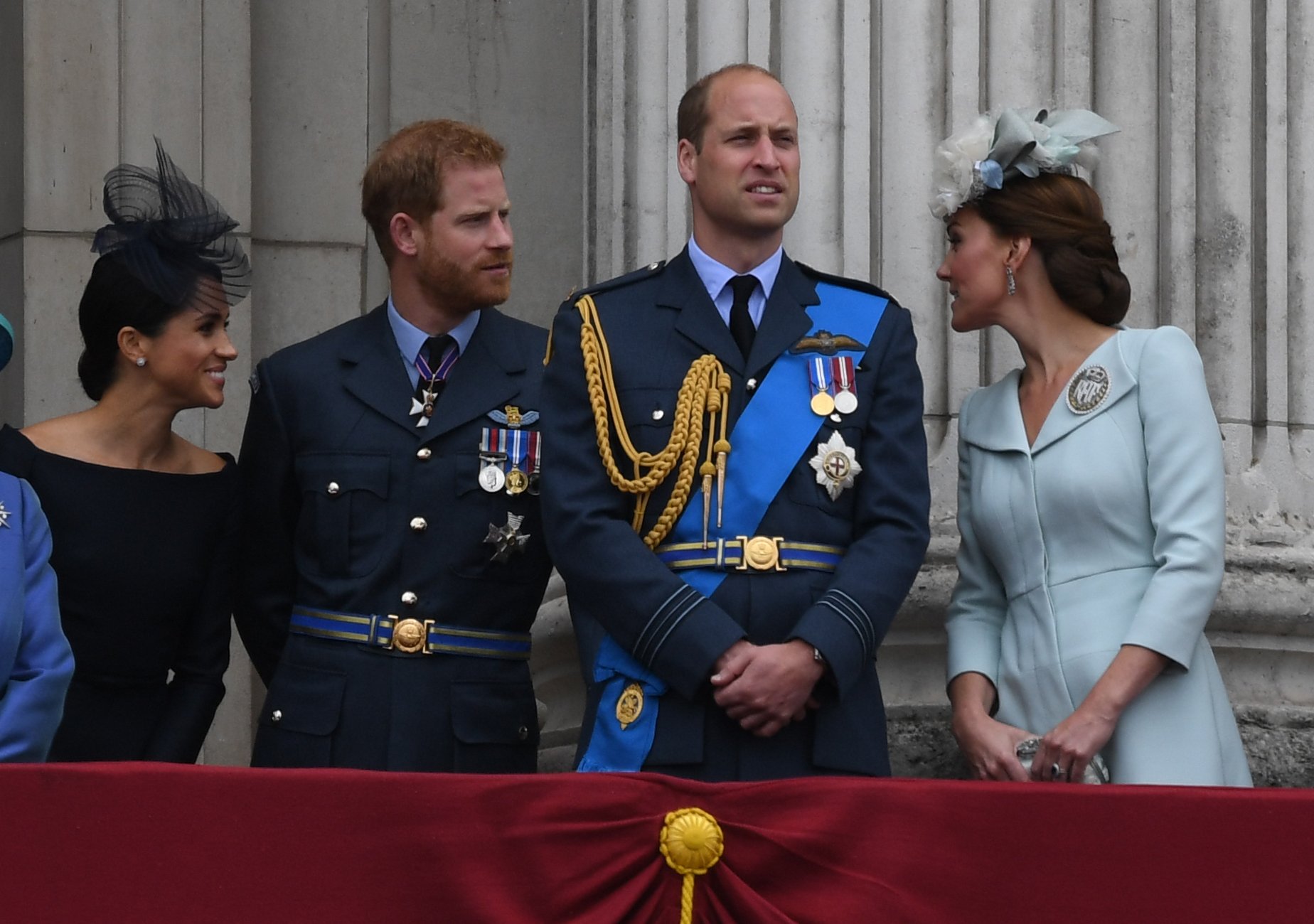 Meghan Markle, Prince Harry, Prince William and Kate Middleton standing on the balcony of Buckingham Palace to view a flypast marking the centenary of the Royal Air Force (RAF) on July 10, 2018 in London, England. / Source: Getty Images