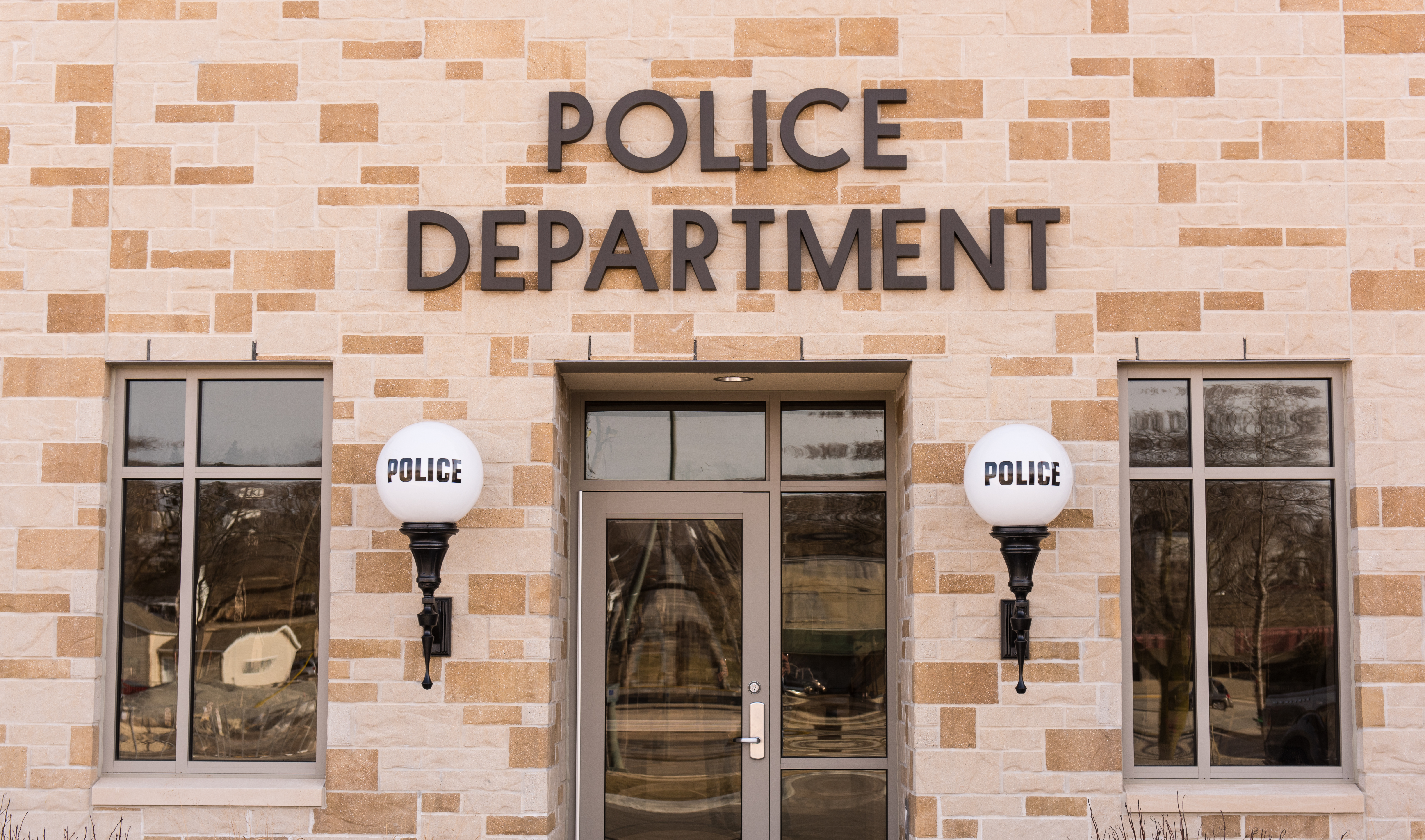 Shot of a police station with lights on both sides of the door that say police on them. | Source: Shutterstock