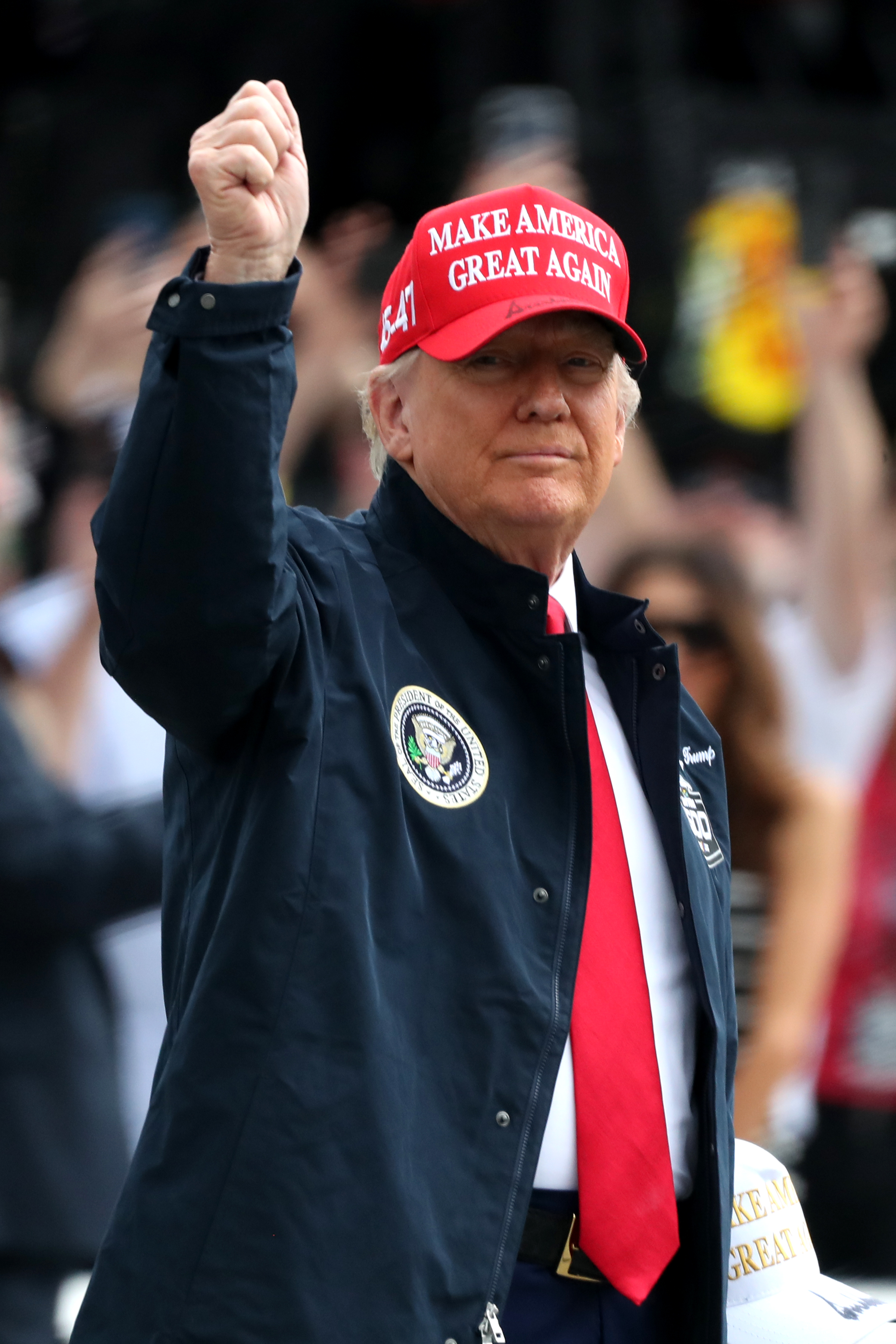 Donald Trump waving to the crowd at the NASCAR Cup Series Daytona 500 on February 16, 2025, in Daytona Beach, Florida. | Source: Getty Images