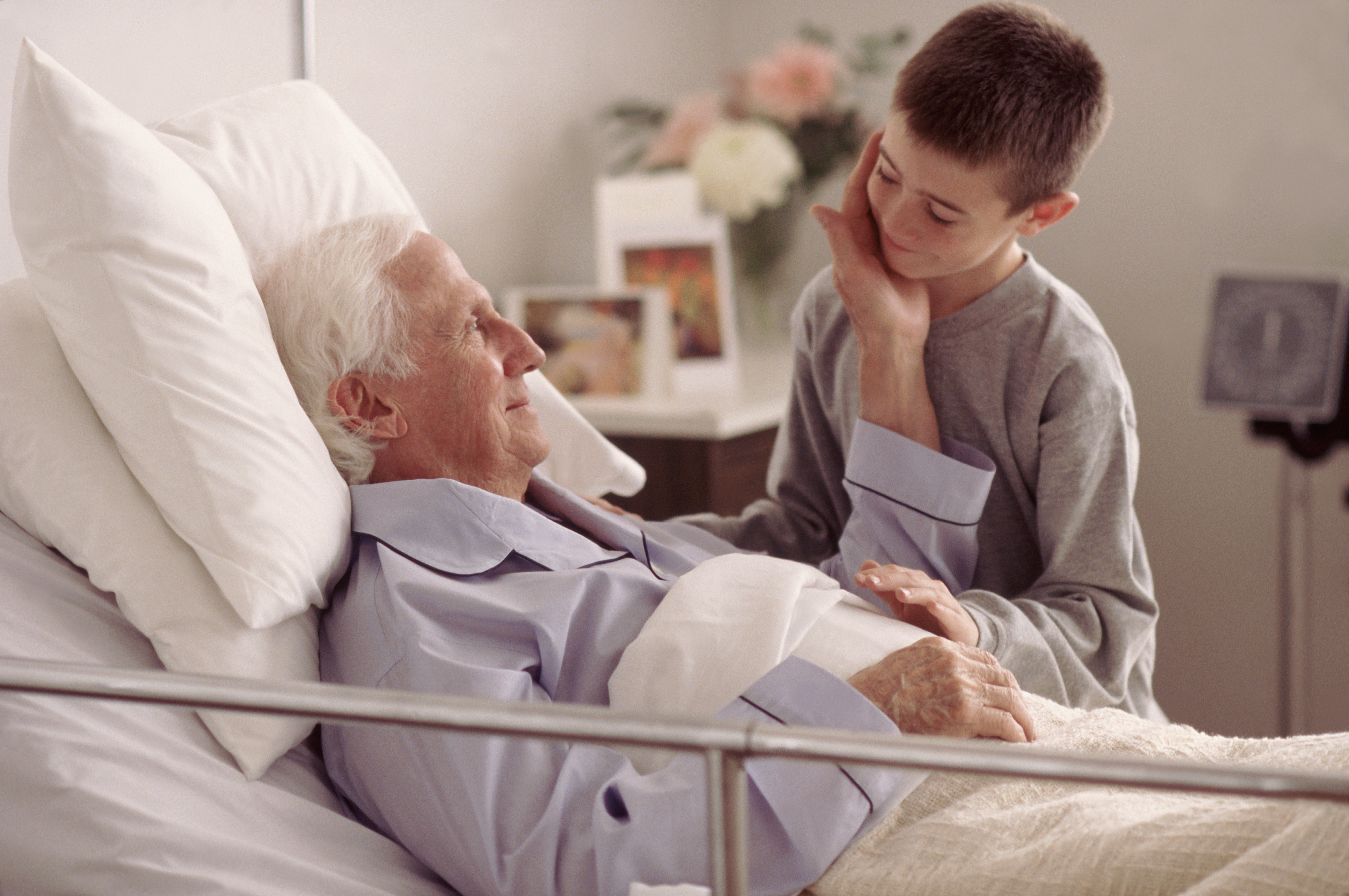 Grandson visiting Grandfather in hospital | Source: Getty Images