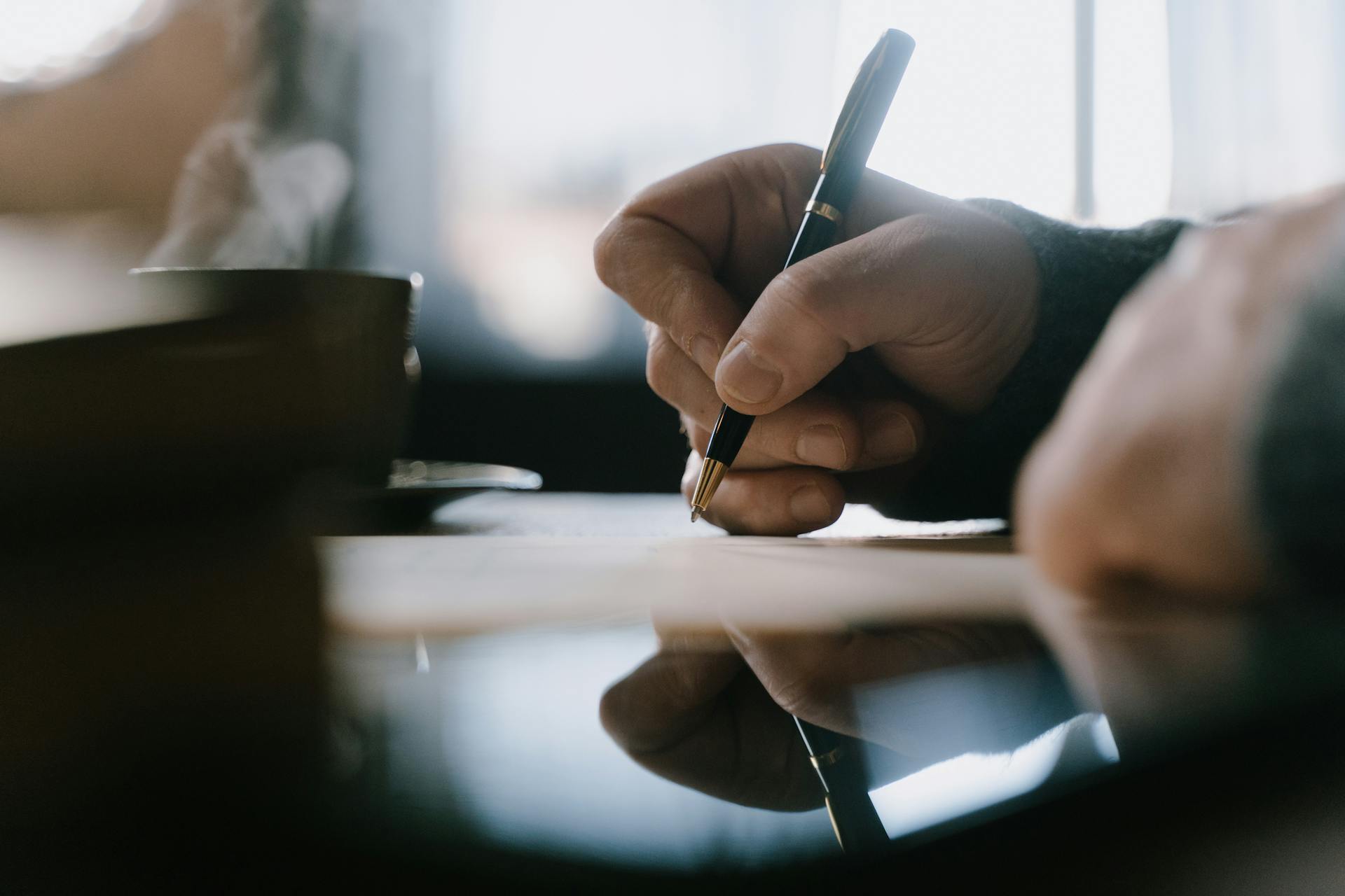A man writing a letter | Source: Pexels
