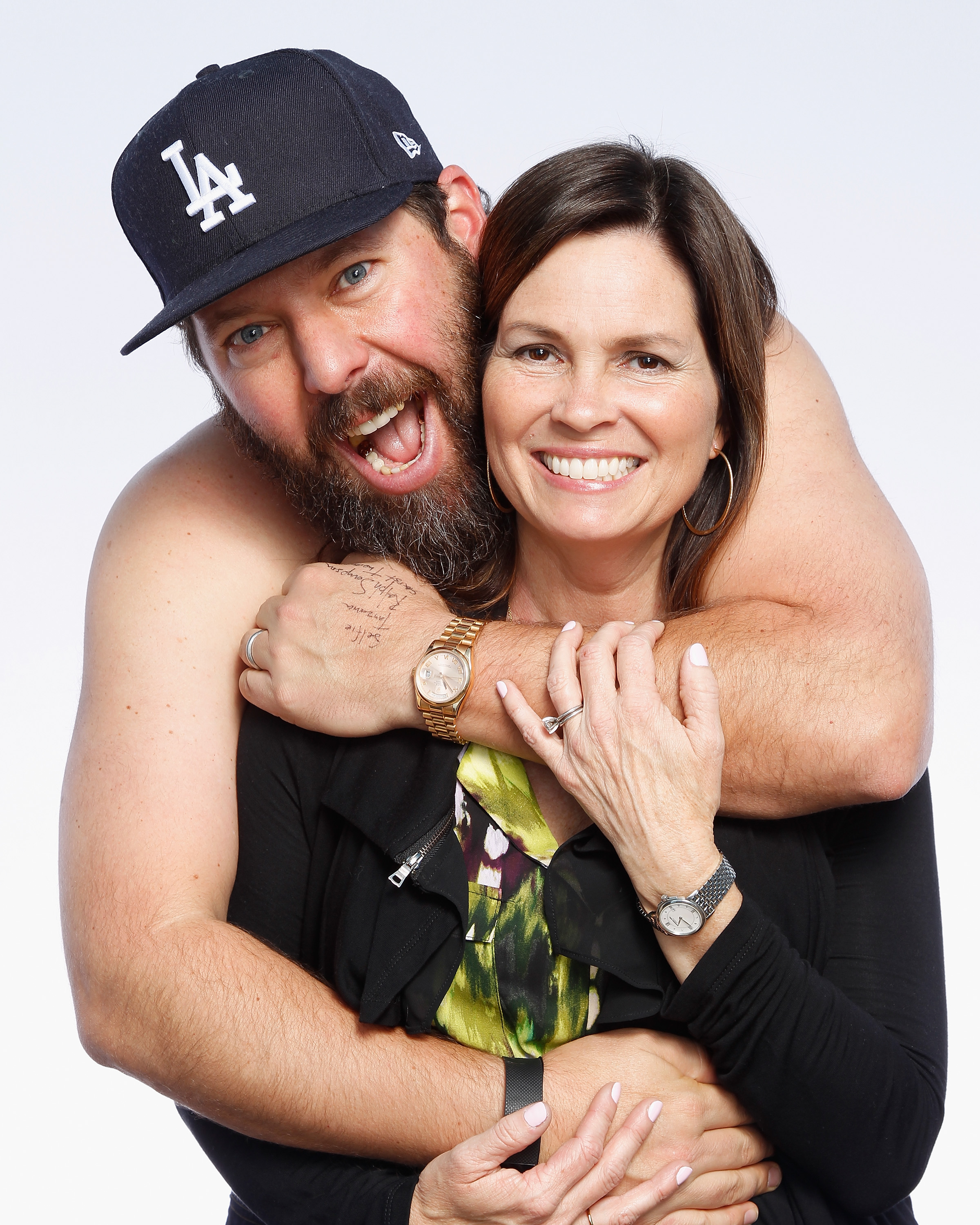 Bert Kreischer (L) poses with his wife Leann Kreischer after his performance at The Ice House Comedy Club, on February 12, 2016, in Pasadena, California. | Source: Getty Images
