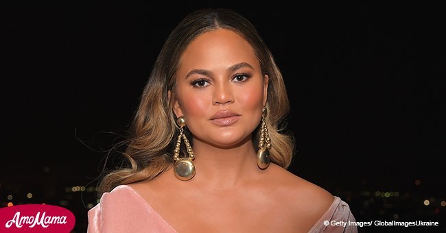 Chrissy Teigen, 32, showcases her huge baby bump as she sports a skintight beige swimsuit