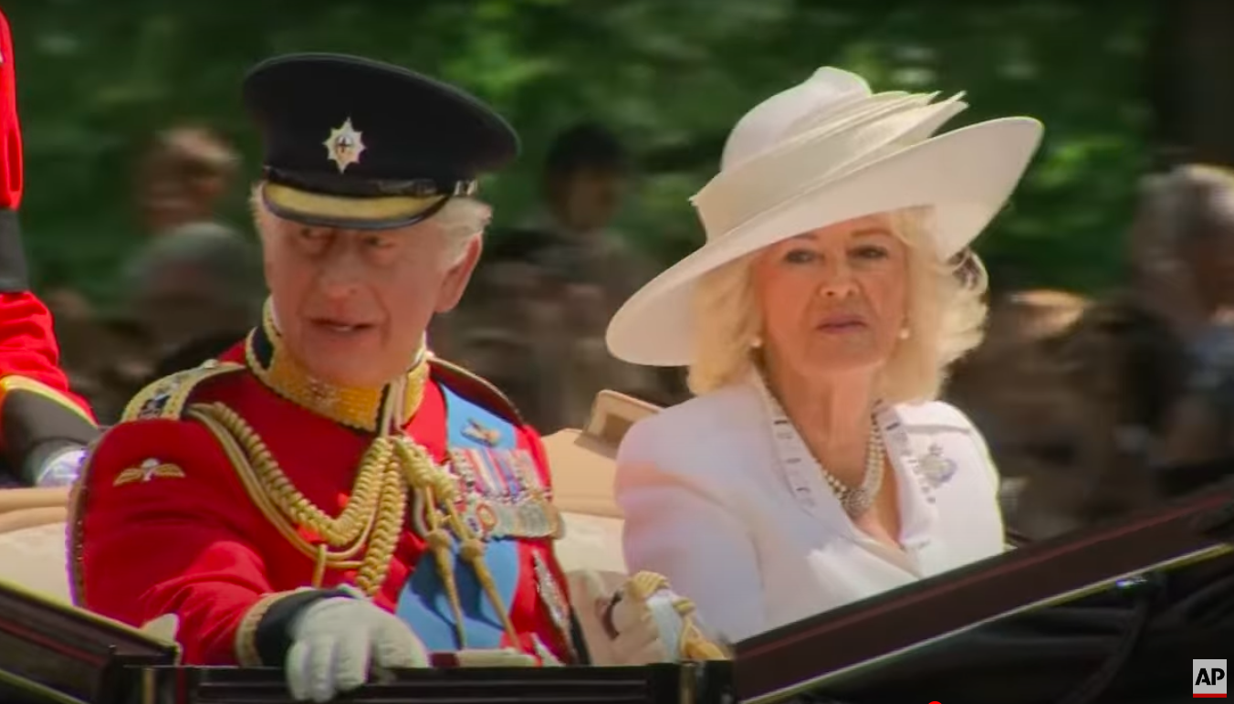King Charles III talking to Queen Camilla during Trooping the Colour, posted on June 14, 2025. | Source: YouTube/Associated Press