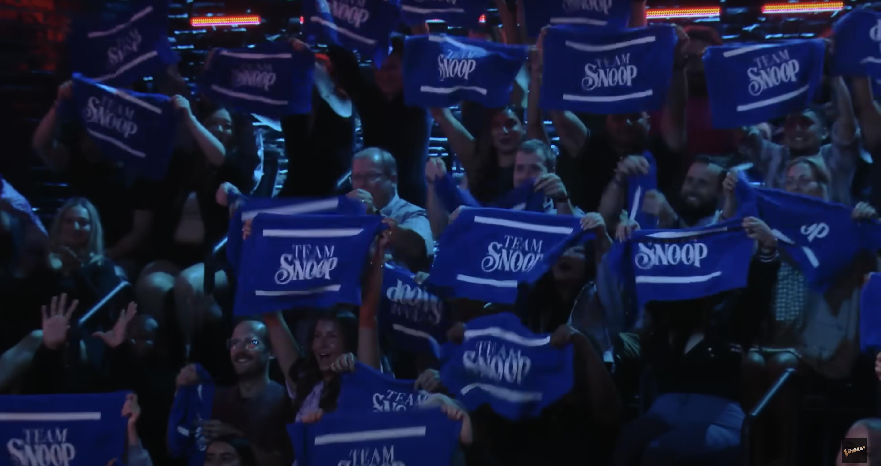 "The Voice" audience holding up a "Team Snoop" sign. | Source: YouTube/The Voice