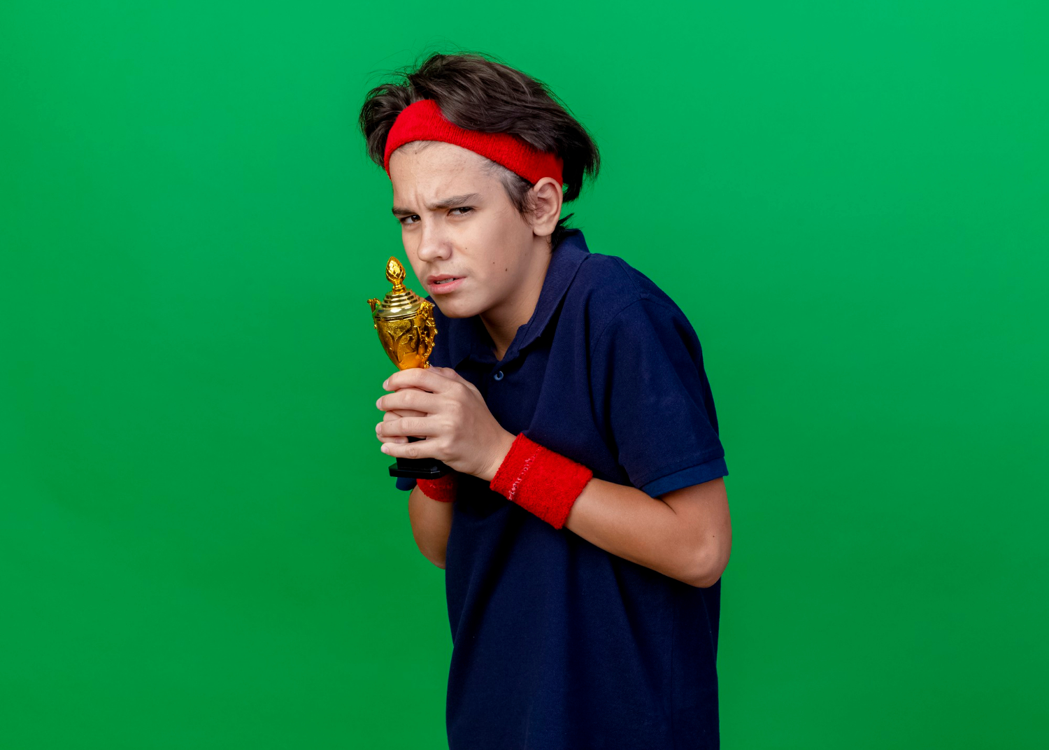 A young boy holding a trophy | Source: Freepik