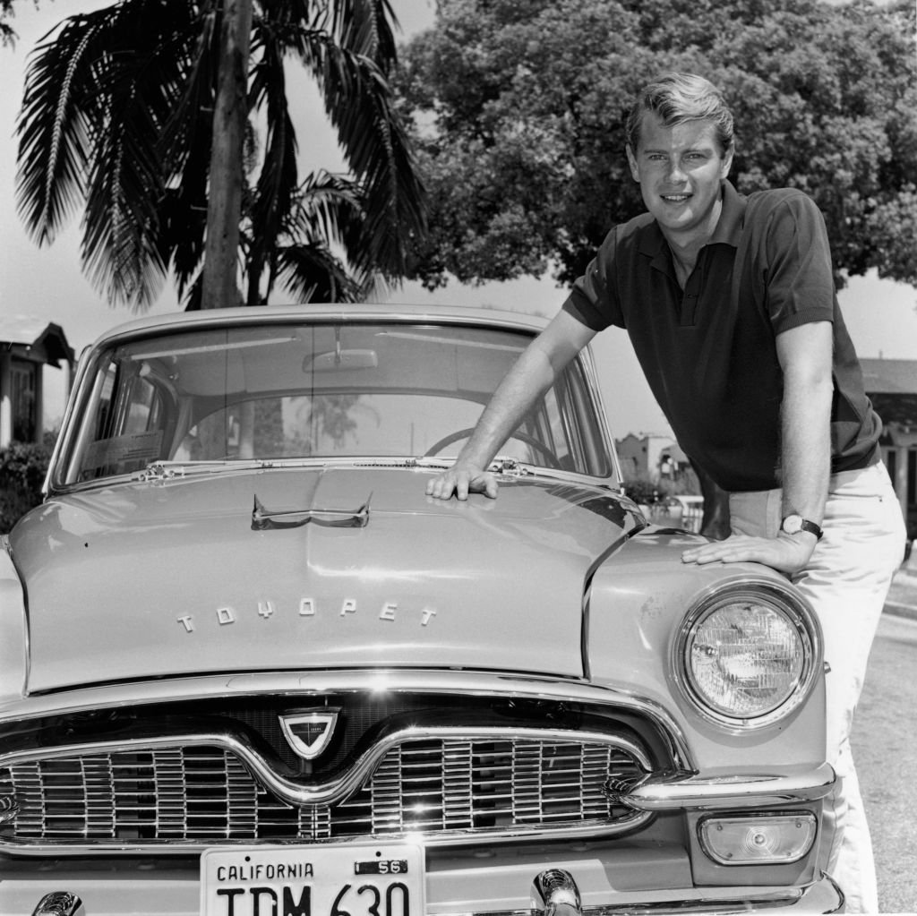 Troy Donahue posing by a car in 1956 in California. | Source: Getty Images