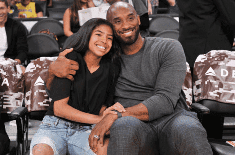 Kobe Bryant and his daughter Gianna Bryant share an embrace at a basketball game between the Los Angeles Lakers and the Atlanta Hawks, at Staples Center, on November 17, 2019 in Los Angeles, California | Source: Allen Berezovsky/Getty Images