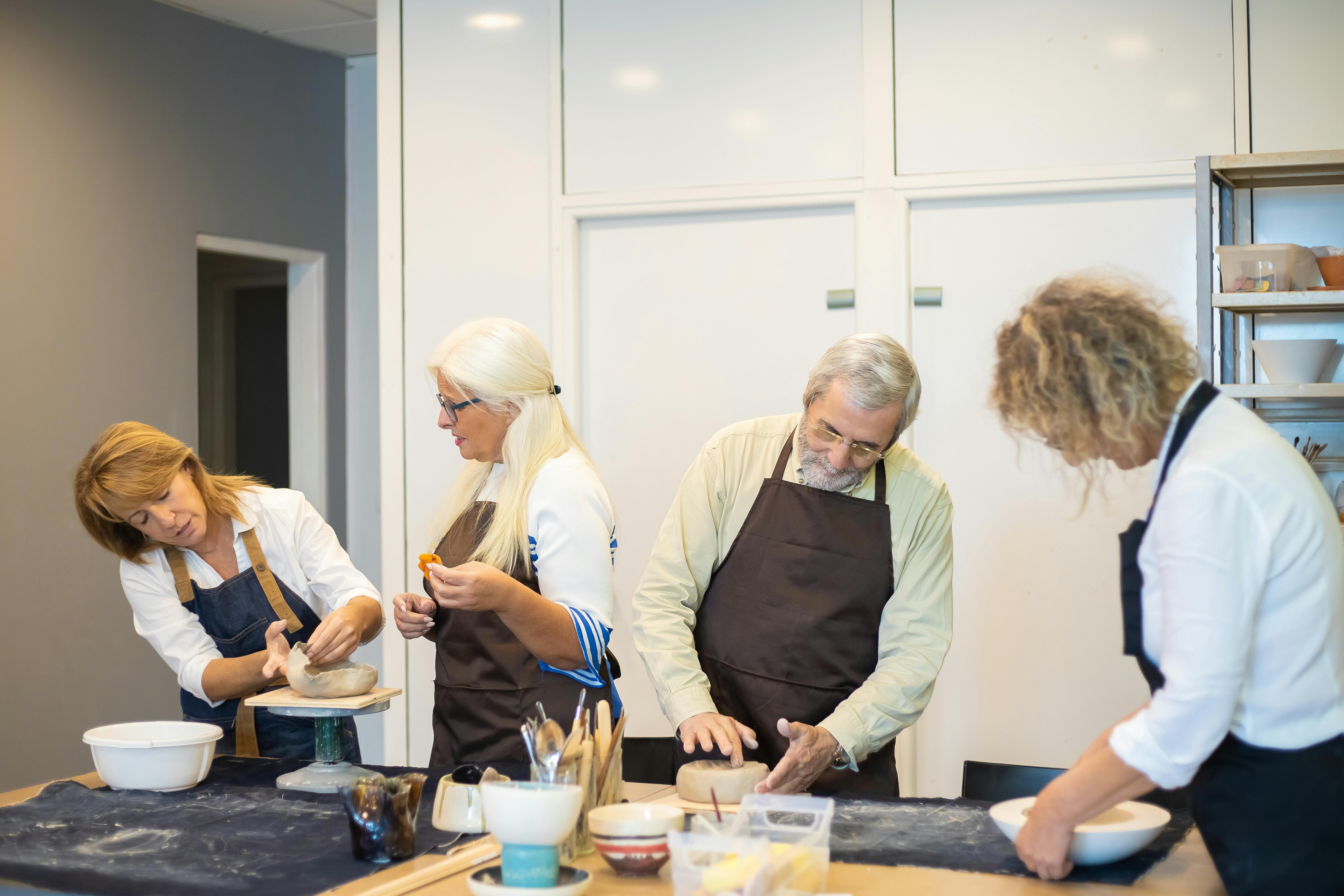 Seniors doing pottery | Source: Pexels